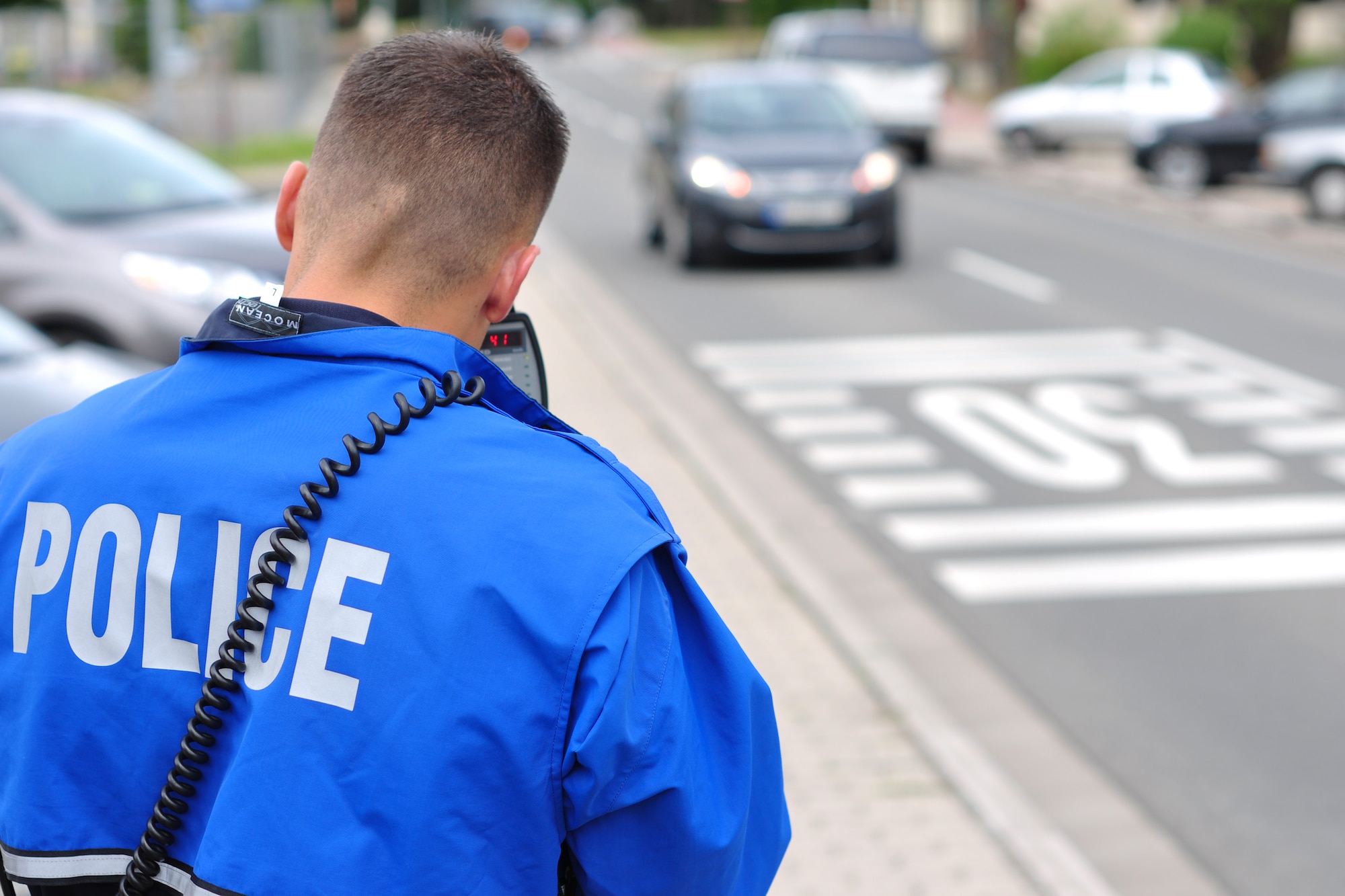Staff Sgt. Gavin Saiz, 86th Security Forces Squadron bike patrol, checks on-coming vehicles’ speed in front of Bldg. 2402 at Ramstein Air Base, Germany, July 31, 2012. Saiz said some of the biggest areas security forces have issues with speeding on base are the areas near the child development center, base library, post office and the 10-kph limit in the Kaiserslautern Military Community Center parking lot. He also warned that there is a seven-day automatic suspension for anyone caught texting at a stop light. (U.S. Air Force photo/Tech. Sgt. Chad Thompson)