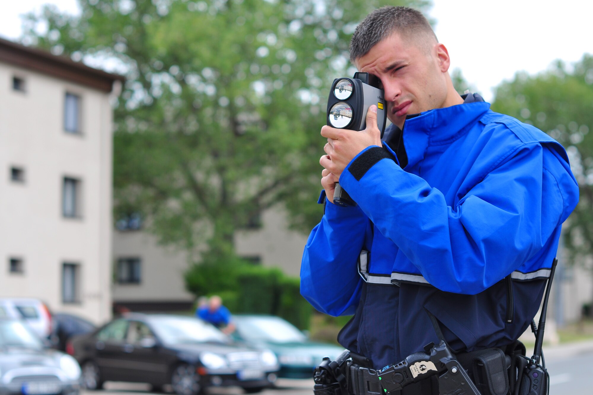 Staff Sgt. Gavin Saiz, 86th Security Forces Squadron bike patrol, checks on-coming vehicles’ speed in front of Bldg. 2402 at Ramstein Air Base, Germany, July 31, 2012. Saiz said some of the biggest areas security forces have issues with speeding on base are the areas near the child development center, base library, post office and the 10-kph limit in the Kaiserslautern Military Community Center parking lot. He also warned that there is a seven-day automatic suspension for anyone caught texting at a stop light. (U.S. Air Force photo/Tech. Sgt. Chad Thompson)
