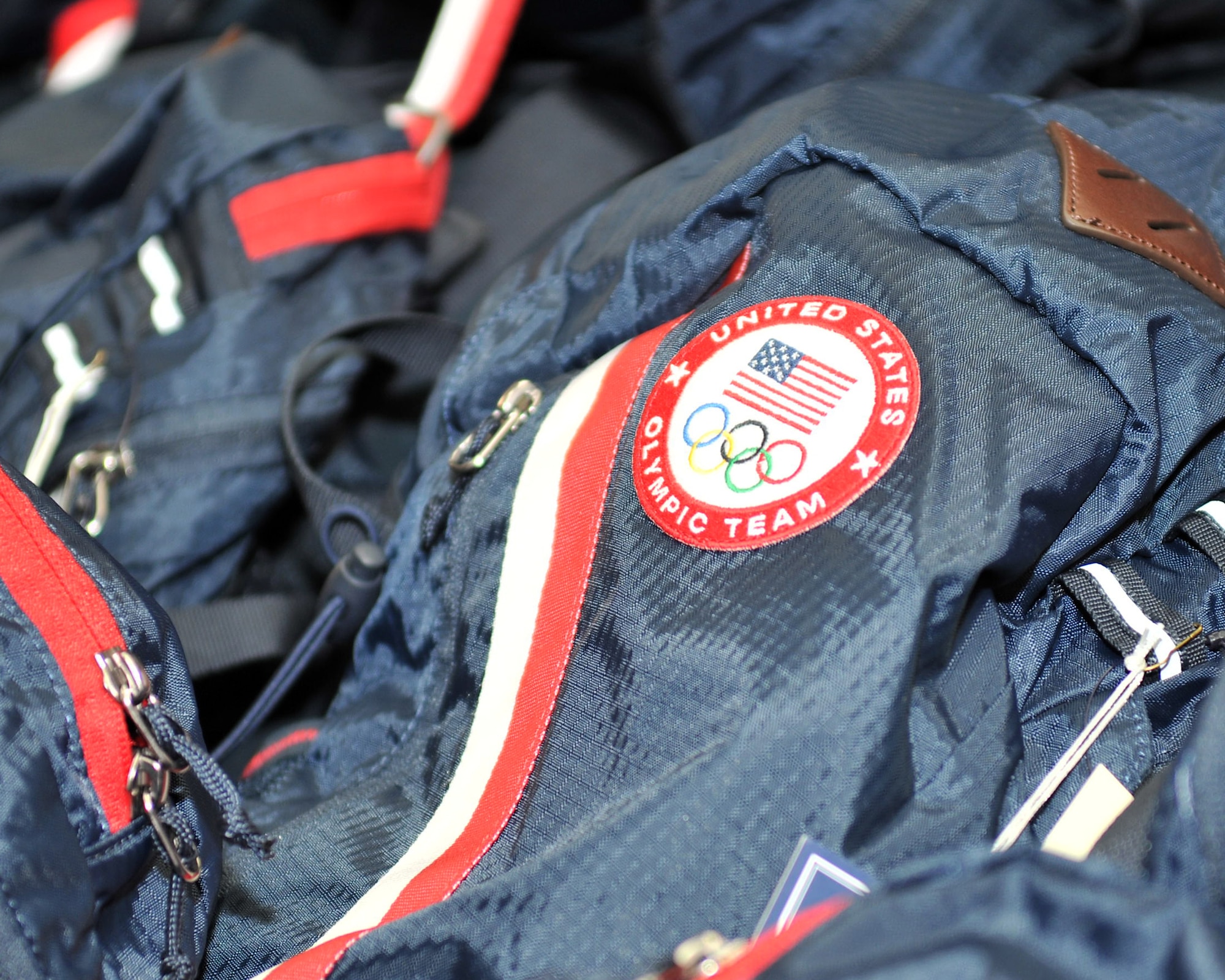 LONDON, England – Bags are issued to the Team USA Olympic athletes containing official sponsored apparel for the 2012 Olympic Games in London July 25, 2012. More than 300 members from U.S. military communities in the United Kingdom volunteered in preparation for the upcoming Olympic Games. (U.S. Air Force photo/Senior Airman Jerilyn Quintanilla) 