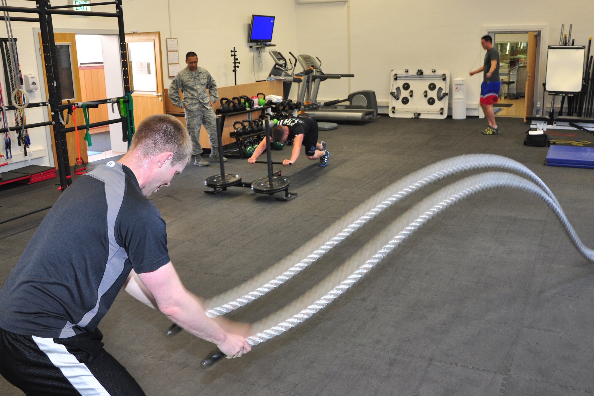 Senior Airman Cody Foster (left), 569th U.S. Forces Police Squadron police services, works out during an advanced physical therapy class at Ramstein Air Base, Germany, July 26, 2012. The three-week class is specially designed for those who are going back to some of the more physically demanding Air Force career fields and it’s used to ensure they have proper form to avoid re-injury at work or during their leisure activities. (U.S. Air Force photo/Tech. Sgt. Chad Thompson)