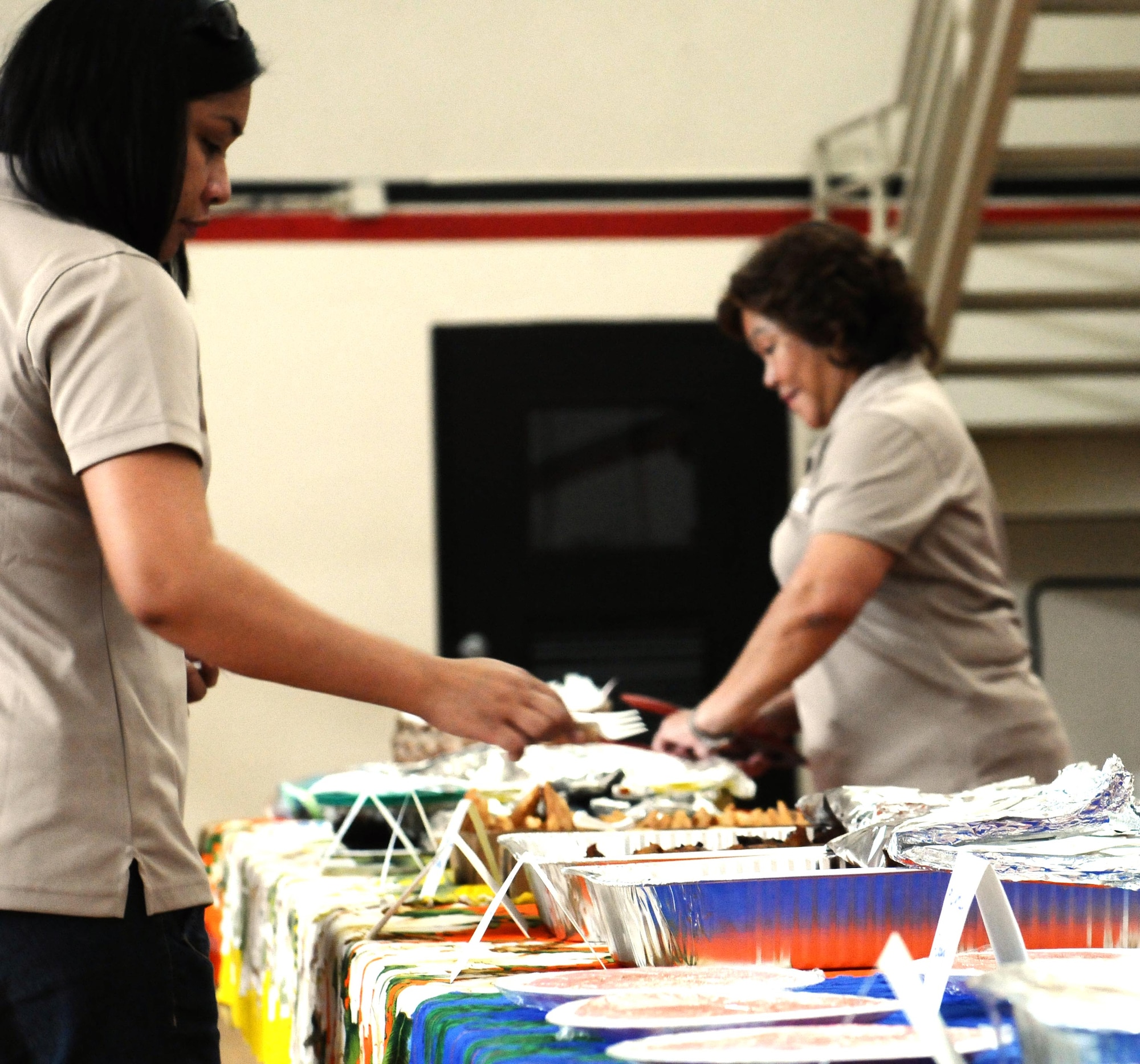 Members of the Hurao Acadamy help set up traditional Chamoru foods for the Chamoru Cultural Festival here July 28. The festival was an event to help Airmen and their families to acclimate to Guam. (U.S. Air Force photo/Airman 1st Class Mariah Haddenham/Released)