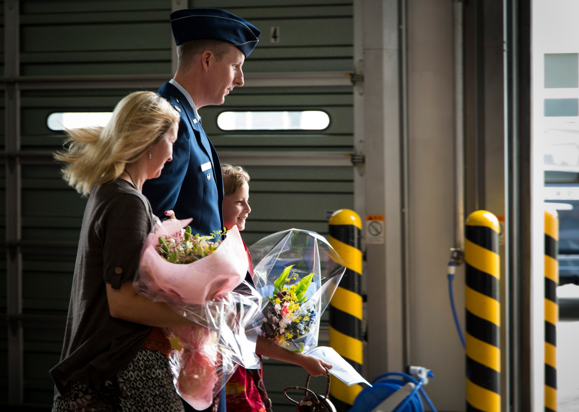 YOKOTA AIR BASE, Japan -- Lt. Col. Christoff Gaub, 374th Civil Engineer Squadron commander, walks with his family following the 374 CES change of command ceremony July 30, 2012, at Yokota Air Base, Japan. The men and women of the squadron presented the members of the Gaub family with flowers, welcoming them to Yokota. (U.S. Air Force photo by Tech. Sgt. Samuel Morse)