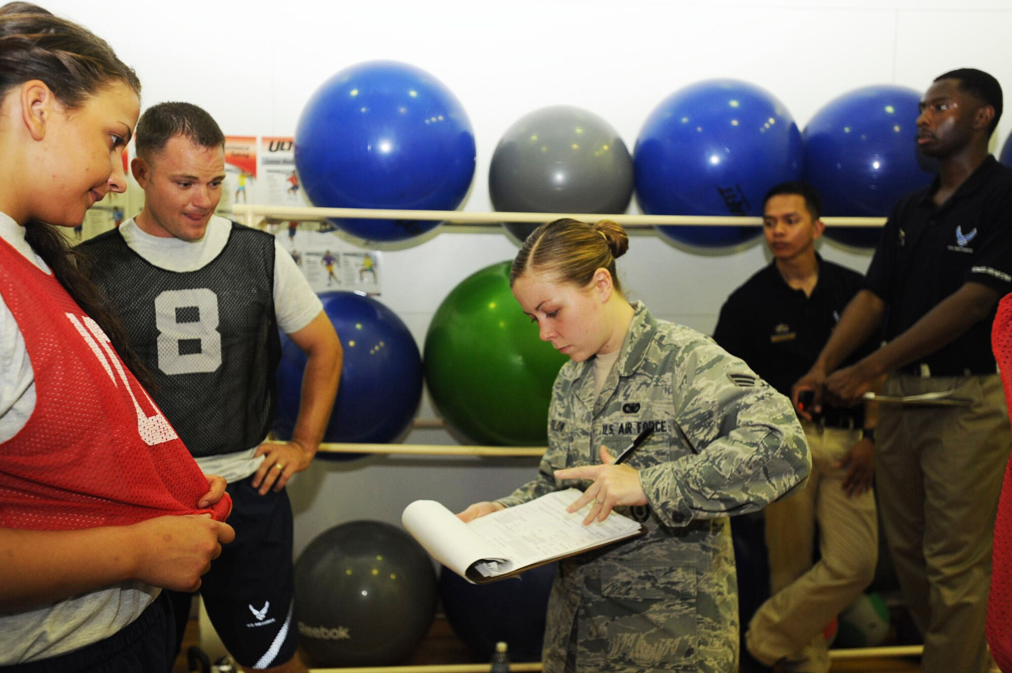 U.S. Air Force Senior Airman Katelyn Farlow, center, 35th Security Forces Squadron security assistant, records the number of push-ups Airmen did during a physical fitness test at Misawa Air Base, Japan, July 31, 2012. Part of a physical training leader’s responsibility is to make sure each member of their shop is physically ready for deployment. (U.S. Air Force photo by Airman 1st Class Kenna Jackson/Released)