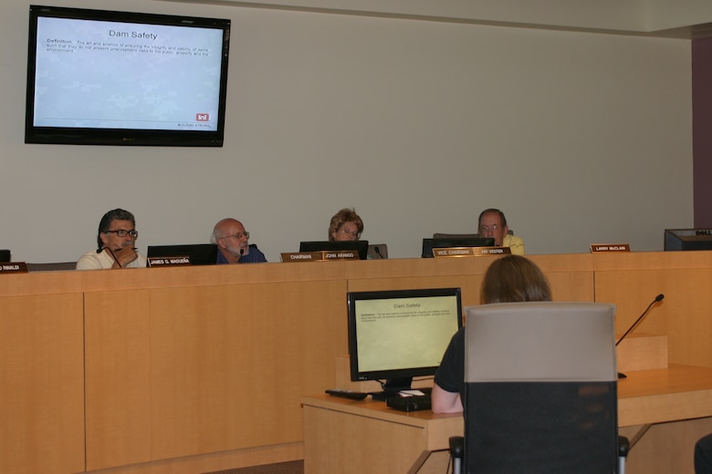 Sandoval County Planning and Zoning Commission members listen as District Dam Safety Manager Suzi Hess-Brittelle discusses risks related to flooding. 