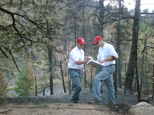 District Civil Engineers Carlos Aragon (left) and John Stages deployed to a forested area near Colorado Springs, Colo., in mid-July to perform a flood risk assessment following the devastating Waldo Canyon Fire.  