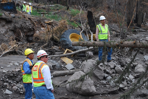 United States Senator Tom Udall (top) and members of the District took a tour of Santa Clara Pueblo’s burned canyon July 7. Udall stands next to a Corps’ bulldozer that was destroyed during flooding following last year’s Las Conchas Fire. Also pictured (bottom right) is Kris Schafer, chief of Project Management, and Walter Dasheno, governor of Santa Clara Pueblo.