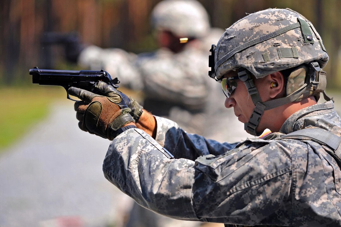 U.S. Army 1st Lt. Thomas Malejko fires his M9 pistol at targets during U.S. Army Europe's Best Junior Officer Competition in Grafenwoehr, Germany, July 24, 2012. Malejko is assigned to the 541st Engineer Company in Bamberg, Germany.