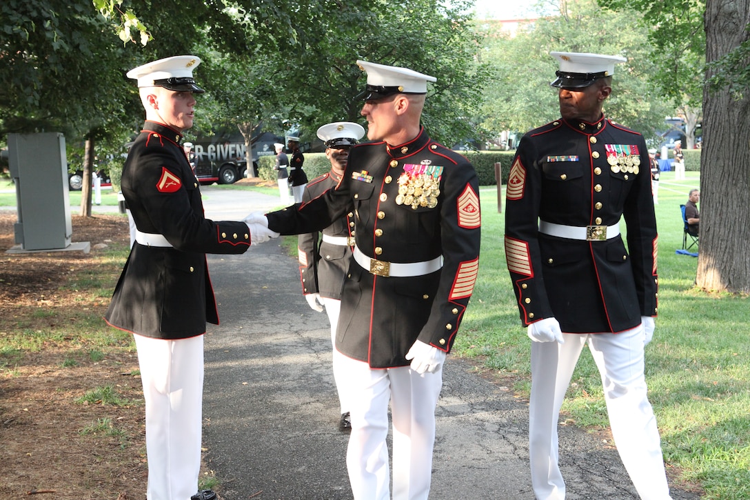 Sgt. Maj. Micheal P. Barrett, the 17th Sergeant Major of the Marine Corps; Shaon Berry, the CEO of Junior Rank; and attendees of the 2012 Sergeant Major of the Marine Corps Symposium attend the Sunset Parade at the Marine Corps War Memorial, Arlington, Va., July 31, 2012.
