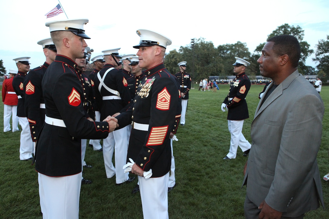Sgt. Maj. Micheal P. Barrett, the 17th Sergeant Major of the Marine Corps; Shaon Berry, the CEO of Junior Rank; and attendees of the 2012 Sergeant Major of the Marine Corps Symposium attend the Sunset Parade at the Marine Corps War Memorial, Arlington, Va., July 31, 2012.