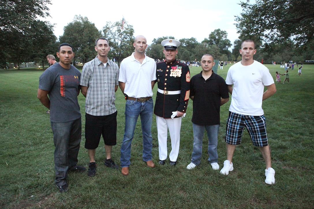 Sgt. Maj. Micheal P. Barrett, the 17th Sergeant Major of the Marine Corps; Shaon Berry, the CEO of Junior Rank; and attendees of the 2012 Sergeant Major of the Marine Corps Symposium attend the Sunset Parade at the Marine Corps War Memorial, Arlington, Va., July 31, 2012.
