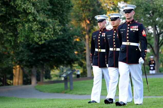The parade staff marches on the parade field at the start of a Tuesday Sunset Parade at the Marine Corps War Memorial in Arlington, Va., July 31. Sgt. Maj. Micheal P. Barrett, sergeant major of the Marine Corps, served as the hosting official for this parade, which featured noncommissioned officers in positions traditionally held by officers and staff NCOs.