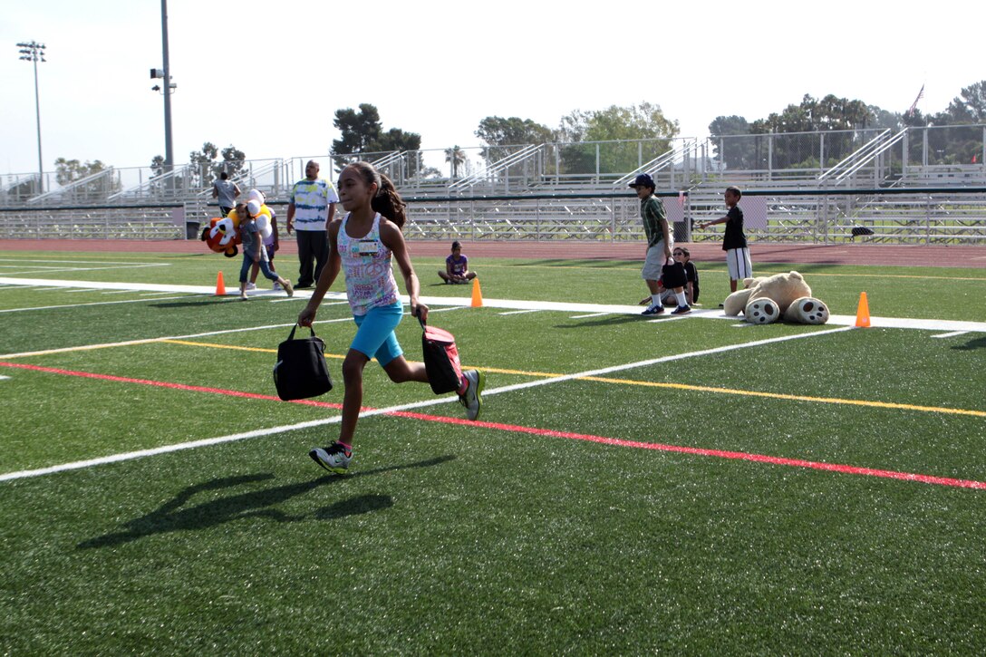 Children participating in Camp Camo get a feel of what their parents do as they run a different version of the Combat Fitness Test at the Paige Fieldhouse, July 31. Everyday, the children are exposed to new outdoor and indoor activities to help them have fun while they stay physically fit and eat right.