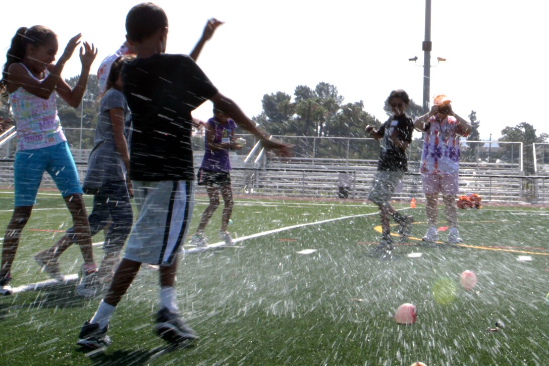 The water balloons toss is one of the activities the children participate in at Camp Camo at the Paige Fieldhouse, July 31. Camp Camo runs one week a year, Monday through Thursday from 9 a.m. to 12:30 p.m.