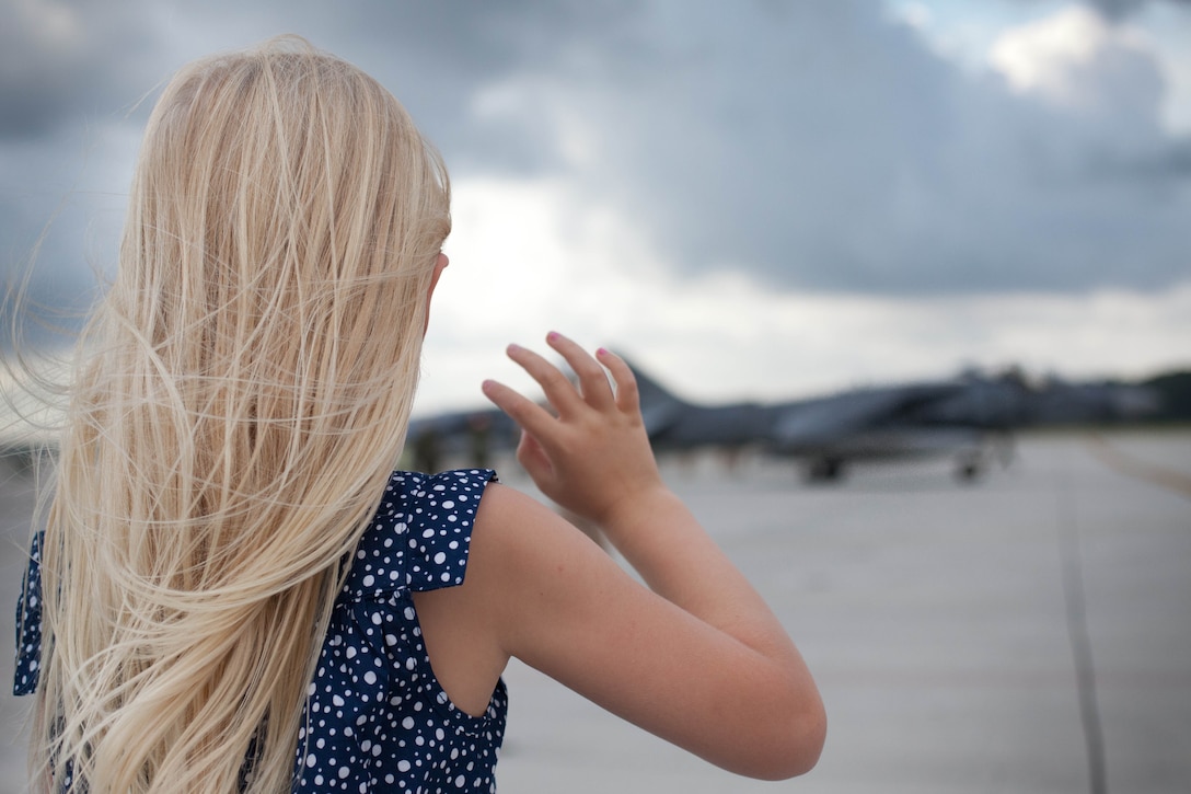 Abby Kate, 5, waves goodbye to her dad, Capt. Michael Wallace, piloting the AV-8B Harrier, on the Marine Corps Air Station Cherry Point flight line, June 1. Wallace deployed with more than 30 fellow Marine Attack Squadron 542 Marines in support of operations in the Pacific with the 31st Marine Expeditionary Unit. (Official U.S. Marine Corps photo by Cpl. Tyler J. Bolken)