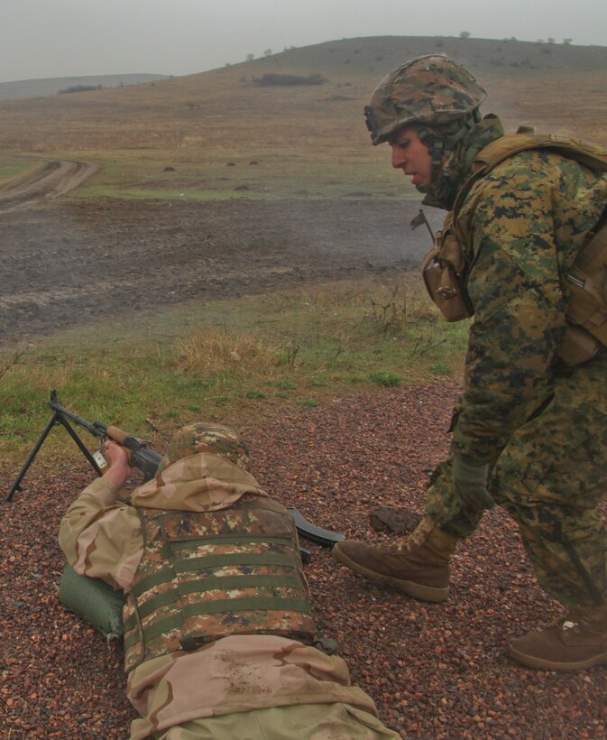 A Marine with Black Sea Rotational Force 12 gives direction to an Armenian soldier on Babadag Training Area. Soldiers from Armenia and Macedonia trained on multiple live-fire ranges with U.S. Marines from Black Sea Rotational Force 12 during the nine-day training.::r::::n::