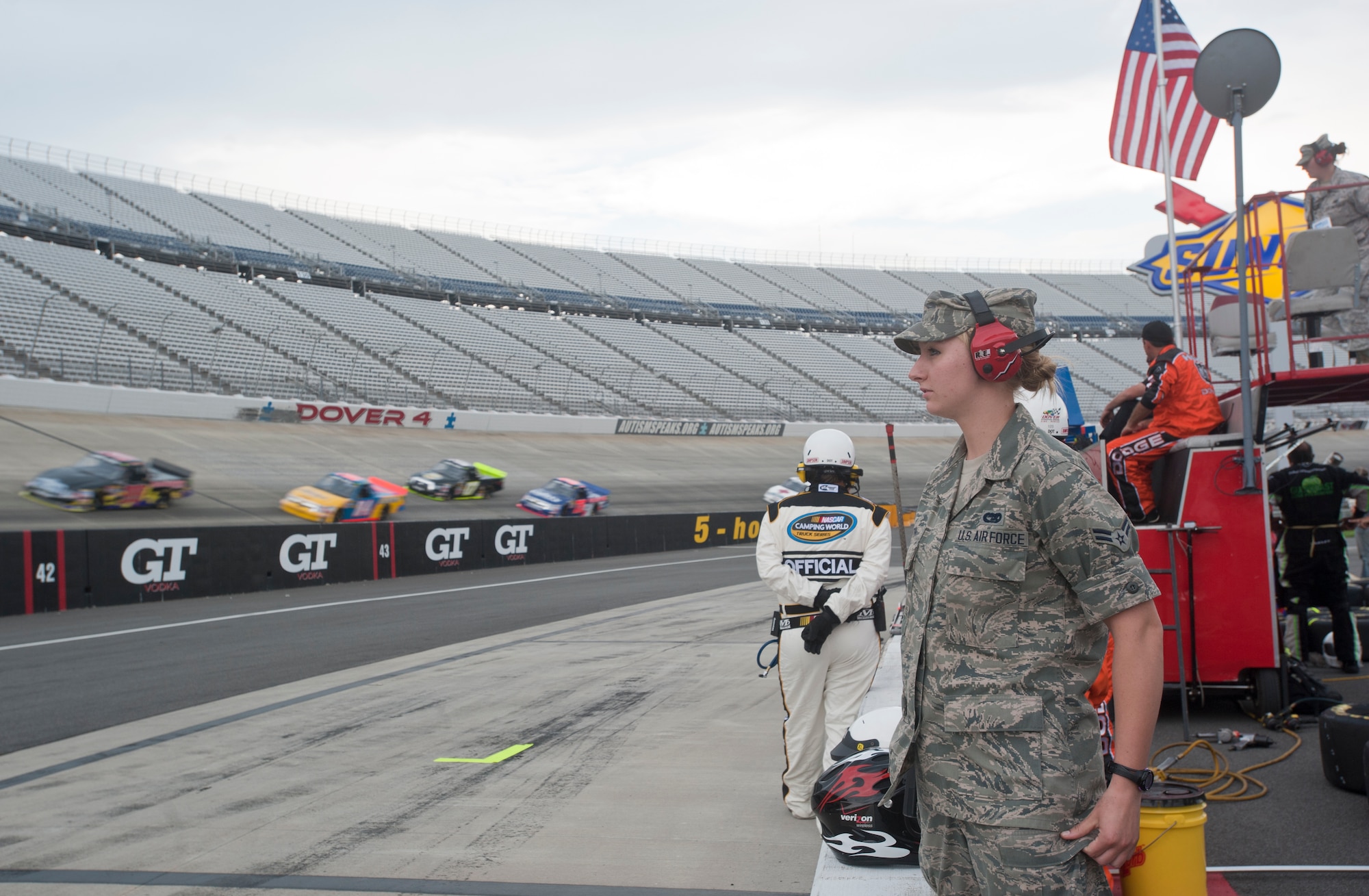 Airman 1st Class Ashley Smith, a cargo processor with the 436th Aerial Port Squadron, stands in the pit with the crew members of the No. 10 Driven 2 Honor team June 1, 2012, at the Lucas Oil 200 at Dover International Speedway, Del. Three female service members were sponsored by Jennifer Jo Cobb racing to get a unique NASCAR experience. (U.S. Air Force photo by Senior Airman Jacob Morgan)