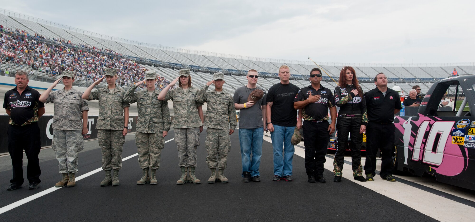 Jennifer Jo Cobb and the No. 10 Driven 2 Honor team stand with members of the 436th Airlift Wing from Dover Air Force Base, Del., at the Lucas Oil 200 June 1, 2012, at Dover International Speedway, Del. Cobb and her team sponsor female service members at every Camping World Truck Series race in which they compete. (U.S. Air Force photo by Senior Airman Jacob Morgan)