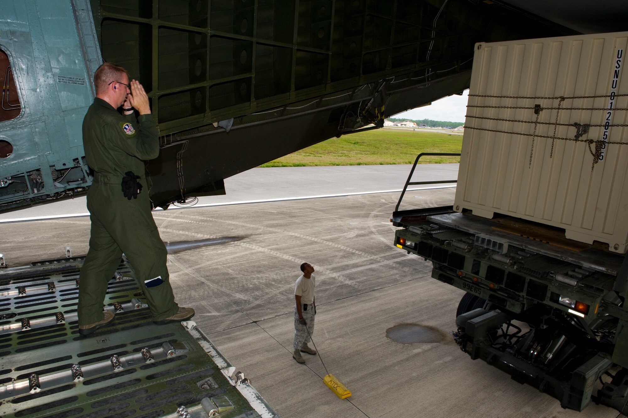 U.S. Air Force Staff Sgt. Erik Richard, a loadmaster with the 337th Airlift Squadron out of Dover Air Force Base, Del., directs an annex onto a C-5 Galaxy on the flightline at Hurlburt Field, Fla., June 1st, 2012. The crew is loading four annexes, one submarine and a pallet onto the aircraft. (U.S. Air Force photo/Airman 1st Class Christopher Williams)(Released)