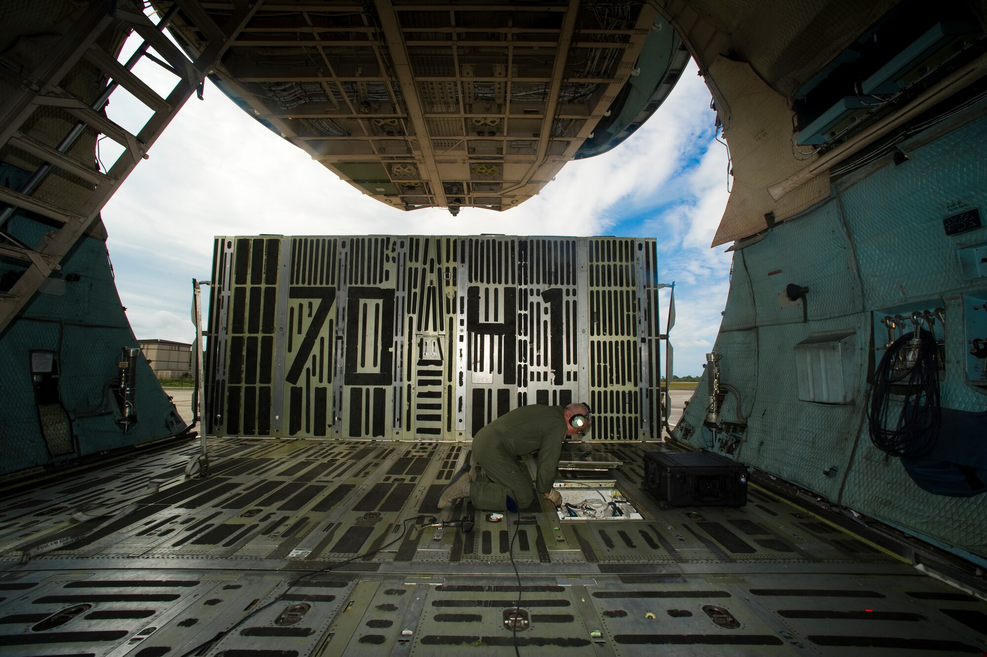 U.S. Air Force Senior Master Sgt. Paul Benson, a C-5 loadmaster Advisor with the 337th Airlift Squadron out of Dover Air Force Base, Del., prepares a rope that will assist in moving cargo onto a C-5 Galaxy on the flightline at Hurlburt Field, Fla., June 1st, 2012. Benson as a loadmaster is flying for his final time. (U.S. Air Force photo/Airman 1st Class Christopher Williams)(Released)