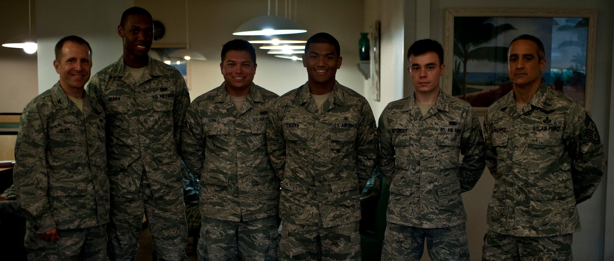Col. Jim Slife, commander of 1st Special Operations Wing, left, and Chief Master Sgt. Sgt. Ramon Colon-Lopez, command chief of 1st SOW, right, pose with (from left to right) Senior Airman James Brown, 1st Special Operations Civil Engineer Squadron, Senior Airman Joshua Gomez, 505th Combat Training Squadron, Airman 1st Class Don Richmon Caluya, 1st Special Operations Medical Operations Squadron, and Airman 1st Class Alexander Kozyerinsky, 801st Special Operations Aircraft Maintenance Squadron, during the Diamond Sharp Award presentation at the Reef Dining Facility at Hurlburt Field, Fla., June 1, 2012. The Diamond Sharp Award is designed to recognize individuals who truly stand out with abilities, sheer drive and characteristic traits most others may not possess. (U.S. Air Force photo / Airman 1st Class Hayden Hyatt) (RELEASED)