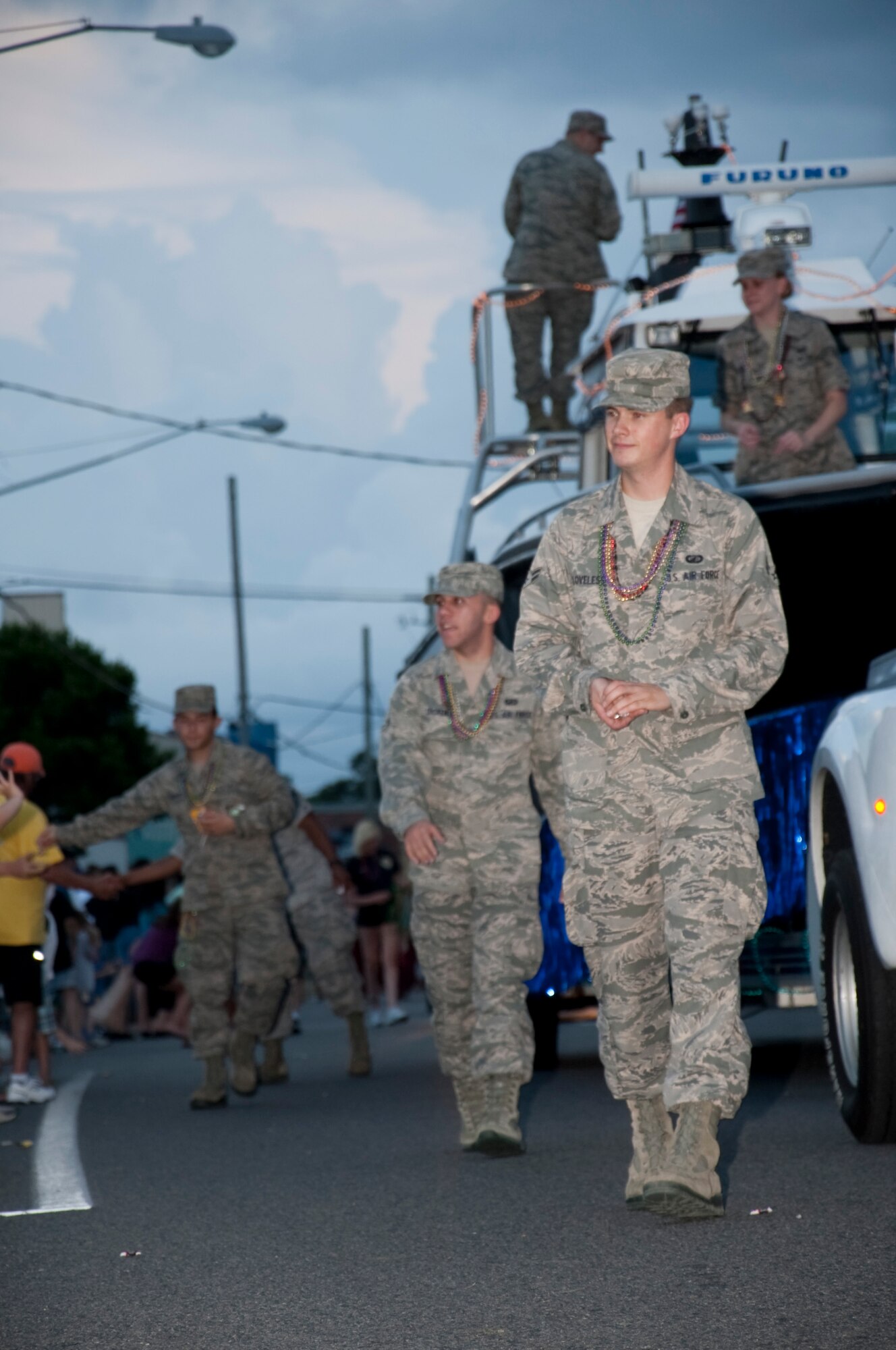 U.S. Air Force Airmen from Hurlburt Field walk alongside a boat from the 1st Special Operations Support Squadron's Range Support Maritime Flight during the 57th Annual Billy Bowlegs Torchlight Parade at Fort Walton Beach, Fla., May 31, 2012. The boat was just one of more than 50 floats in the parade. (U.S. Air Force photo / Airman 1st Class Benjamin Kim)(RELEASED)