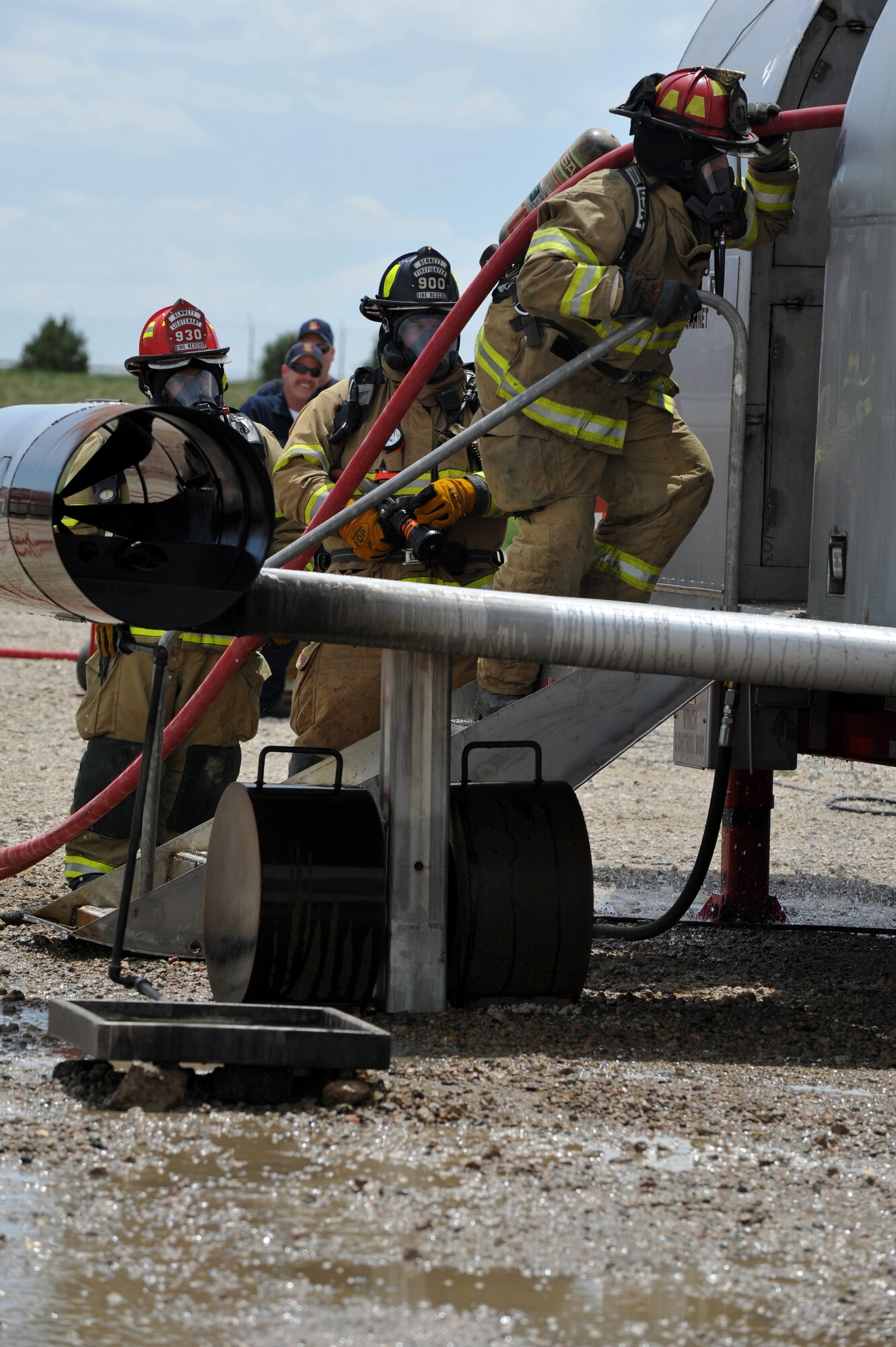 BUCKLEY AIR FORCE BASE, Colo. -- Aurora firefighters enter a mobile air fire trainer to during an exercise May 30, 2012. (U.S. Air Force photo by Airman 1st Class Darryl Bolden Jr.)
