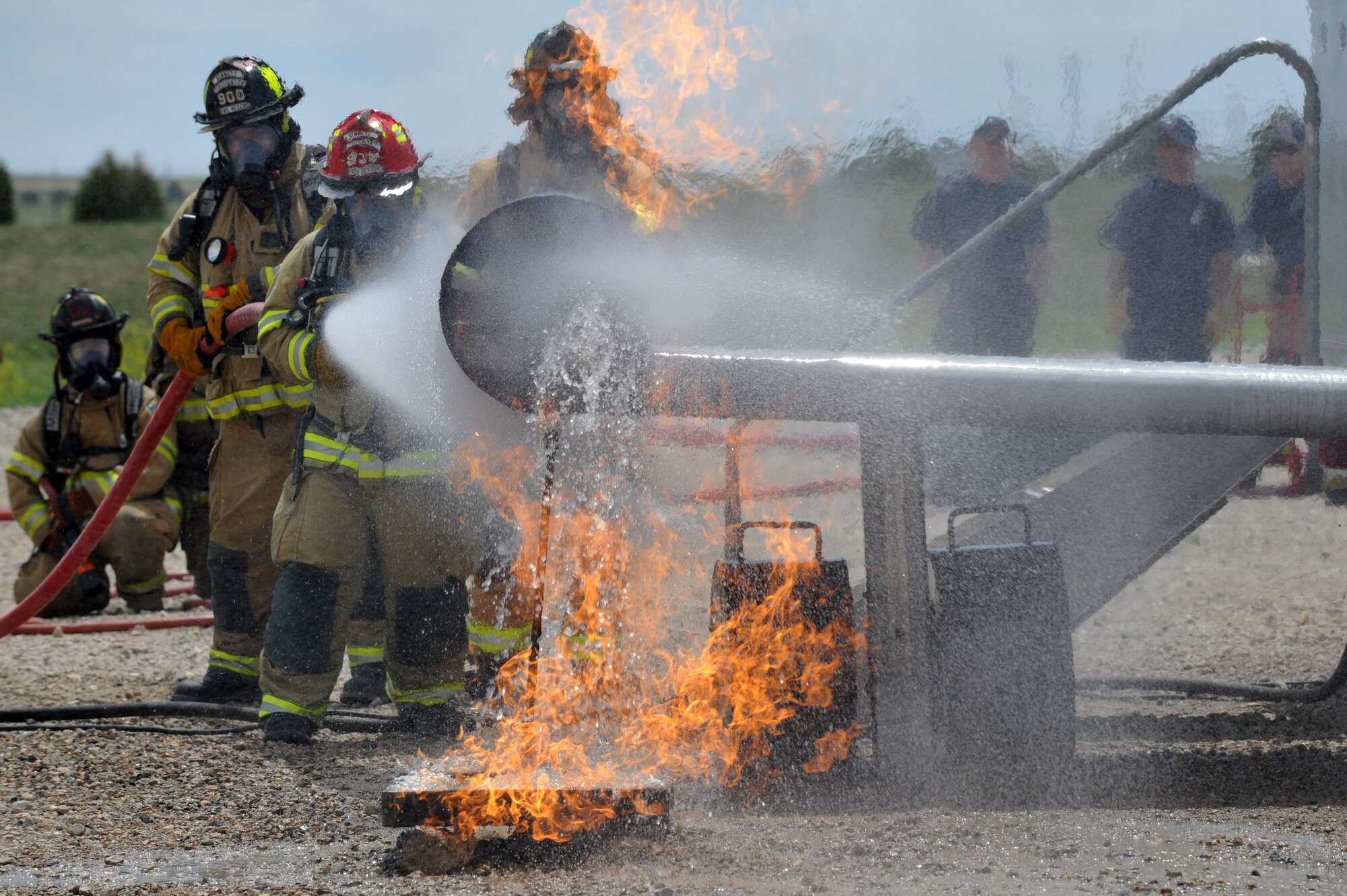 BUCKLEY AIR FORCE BASE, Colo.-- Members of the Aurora and Buckley Fire Departments put out a fire during a training exercise May 30, 2012. The training not only benefits Buckley, but local fire departments as well. (U.S. Air Force photo by Airman 1st Class Darryl Bolden Jr.)
