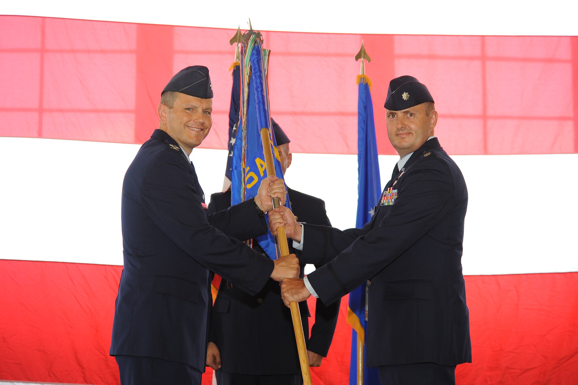 Colonel Charles Corcoran, 325th Operations Group commander, passed the 325th Air Control Squadron guidon to Lieutenant Col. Gary Smith, 325th ACS commander, during the change of command ceremony, June 1. (U.S. Air Force photo by Lisa Norman)