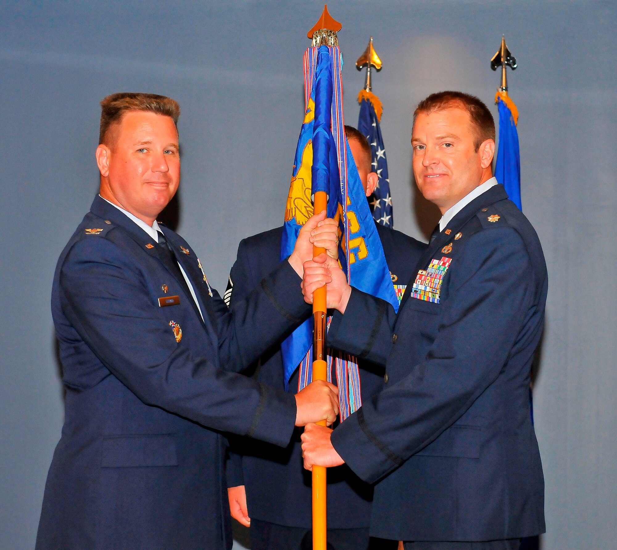 Colonel William Grund, 325th Mission Support Group commander, passed the 325th Civil Engineer Squadron guidon to Lieutenant Col. Brian Stumpe, 325th CES commander, during the change of command ceremony, June 1. (U.S. Air Force photo by Christopher Cokeing)