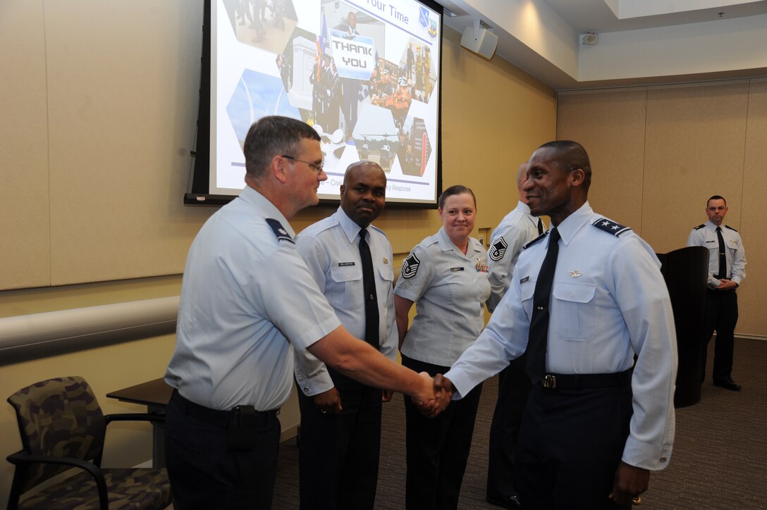 Air Force District of Washington Commander Maj. Gen. Darren W. McDew thanks Capital Airmen Course Director Lt. Col. John Brooks and course coordinators Chief Master Sgt. John Millington and Master Sgt. Erika Perrin. AFDW’s Capital Airmen course is one of many efforts over the past two years designed to deliberately develop AFDW Airmen, Brooks said. (U.S. Air Force photo by Aletha Frost)