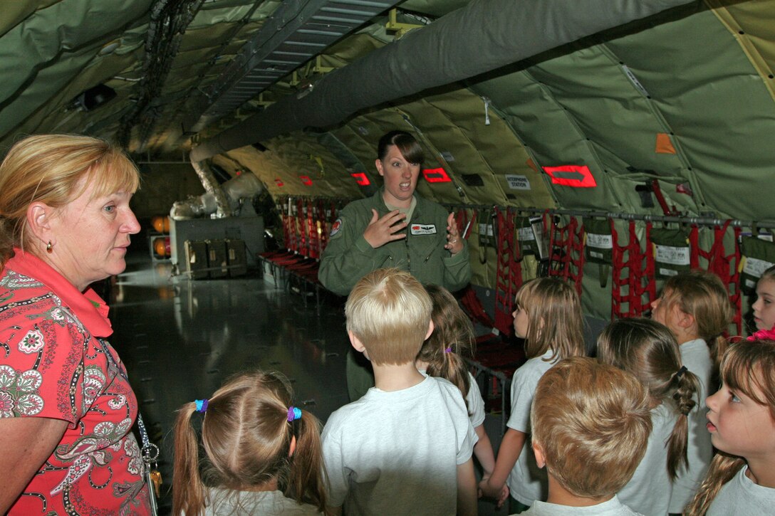 Tech. Sgt. Jennifer Bowen, a boom operator with the 108th Wing, explains her role during an air refueling mission to several students from a local school visiting the base. The 108th Wing provided a base tour to more than 60 students from Saint Josephs Grade School, Toms River, N.J., May 30 at Joint Base McGuire-Dix-Lakehurst, N.J. The seven and eight-year old students were brought on board a KC-135 Stratotanker and provided with a tour of the aircraft, which included a visit to the cockpit and the aft section. (U.S. Air Force photo by Staff Sgt. Armando Vasquez, 108th WG/PA)