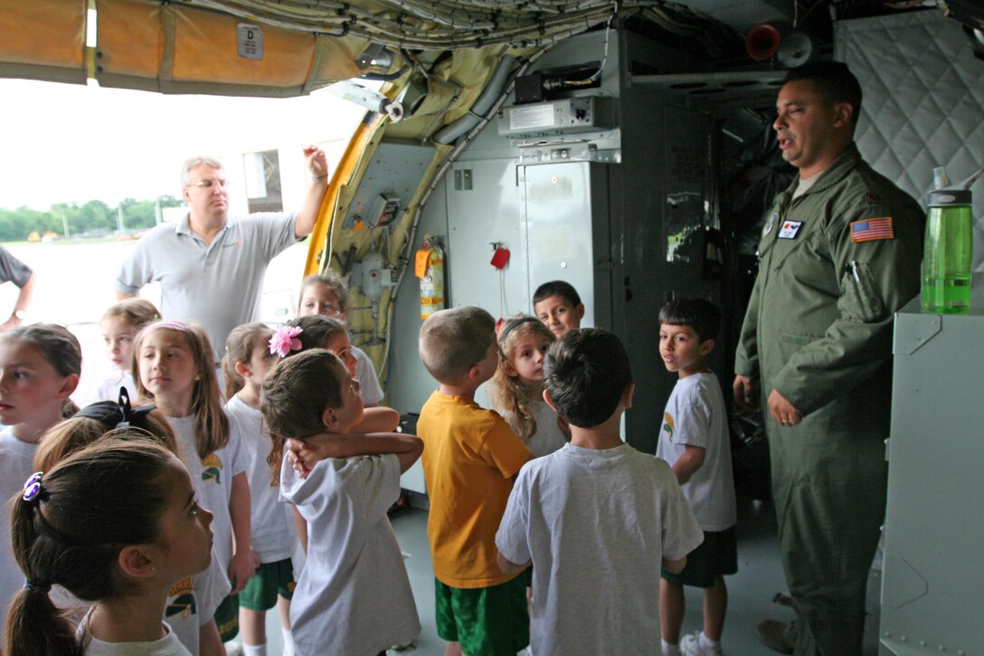 Maj. Matthew S. Brito, a pilot with the 108th Wing, welcomes to the aircraft several students from a local school visiting the base. The 108th Wing provided a base tour to more than 60 students from Saint Josephs Grade School, Toms River, N.J., May 30 at Joint Base McGuire-Dix-Lakehurst, N.J. The seven and eight-year old students were brought on board a KC-135 Stratotanker and provided with a tour of the aircraft, which included a visit to the cockpit and the aft section. (U.S. Air Force photo by Staff Sgt. Armando Vasquez, 108th WG/PA)