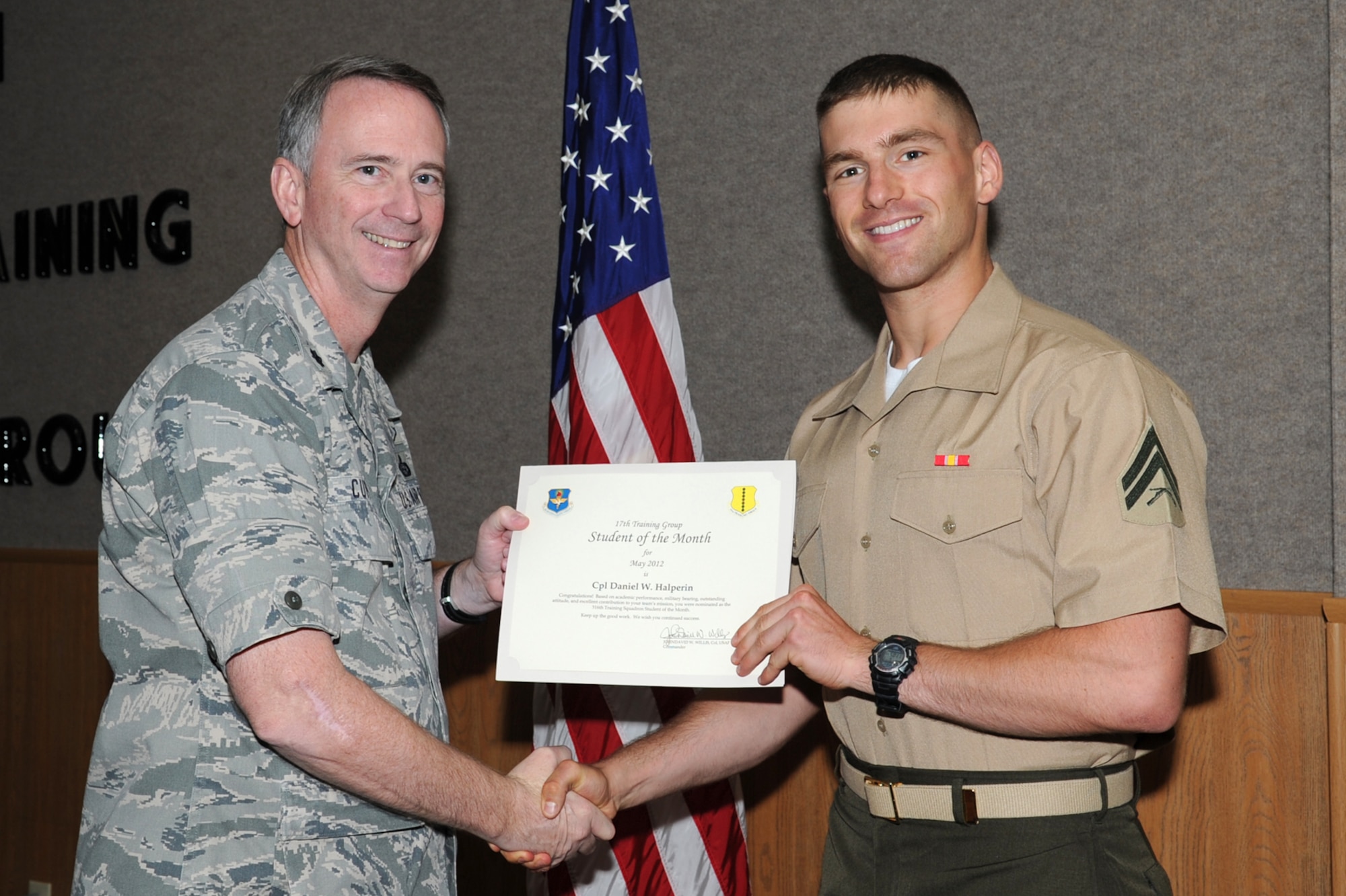 U.S. Air Force Lt. Col. Andrew Cupp, 17th Training Group Deputy Commander, presents U.S. Marine Corps Cpl. Daniel Halperin with the 316th Training Squadron Student of the Month award for May at Goodfellow Air Force Base, Texas, June 2, 2012. (U.S. Air Force photo/Staff Sgt. Laura R. McFarlane)