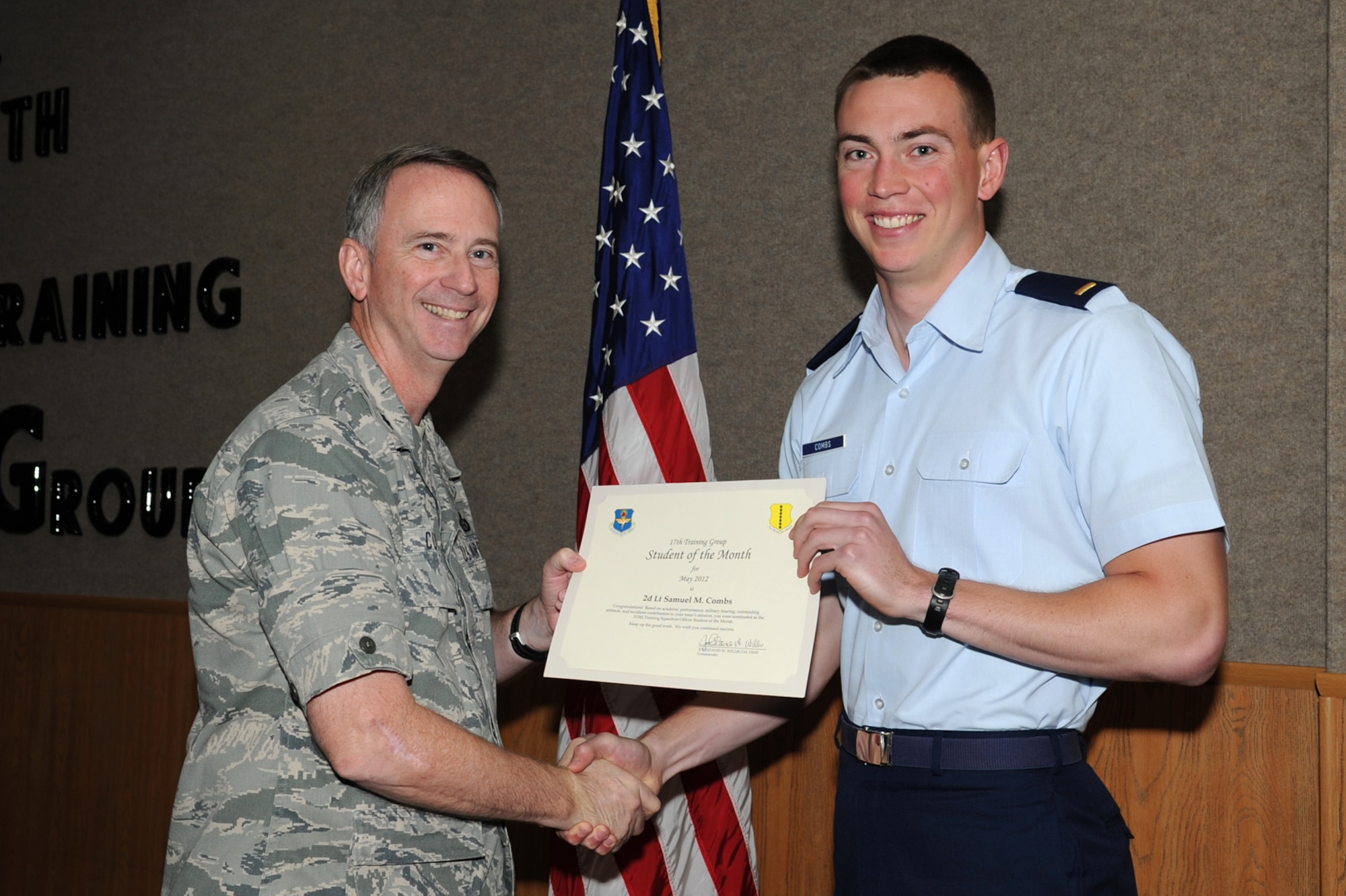 U.S. Air Force Lt. Col. Andrew Cupp, 17th Training Group Deputy Commander, presents U.S. Air Force 2nd Lt. Samuel Combs with the 315th Training Squadron Officer Student of the Month award for May at Goodfellow Air Force Base, Texas, June 2, 2012. (U.S. Air Force photo/Staff Sgt. Laura R. McFarlane)