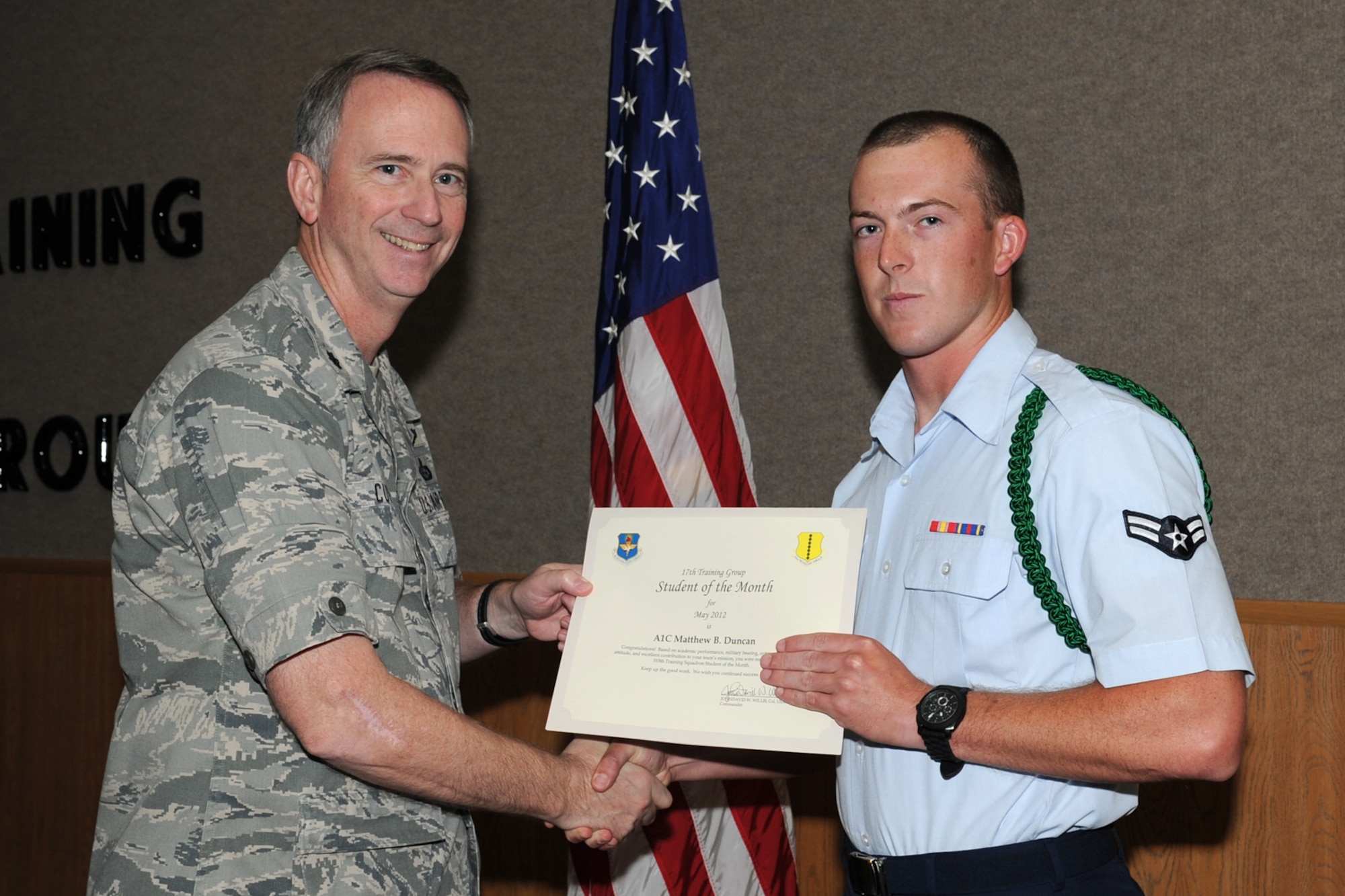 U.S. Air Force Lt. Col. Andrew Cupp, 17th Training Group Deputy Commander, presents U.S. Air Force Airman 1st Class Matthew Duncan with the 315th Training Squadron Enlisted Student of the Month award for May at Goodfellow Air Force Base, Texas, June 2, 2012. (U.S. Air Force photo/Staff Sgt. Laura R. McFarlane)