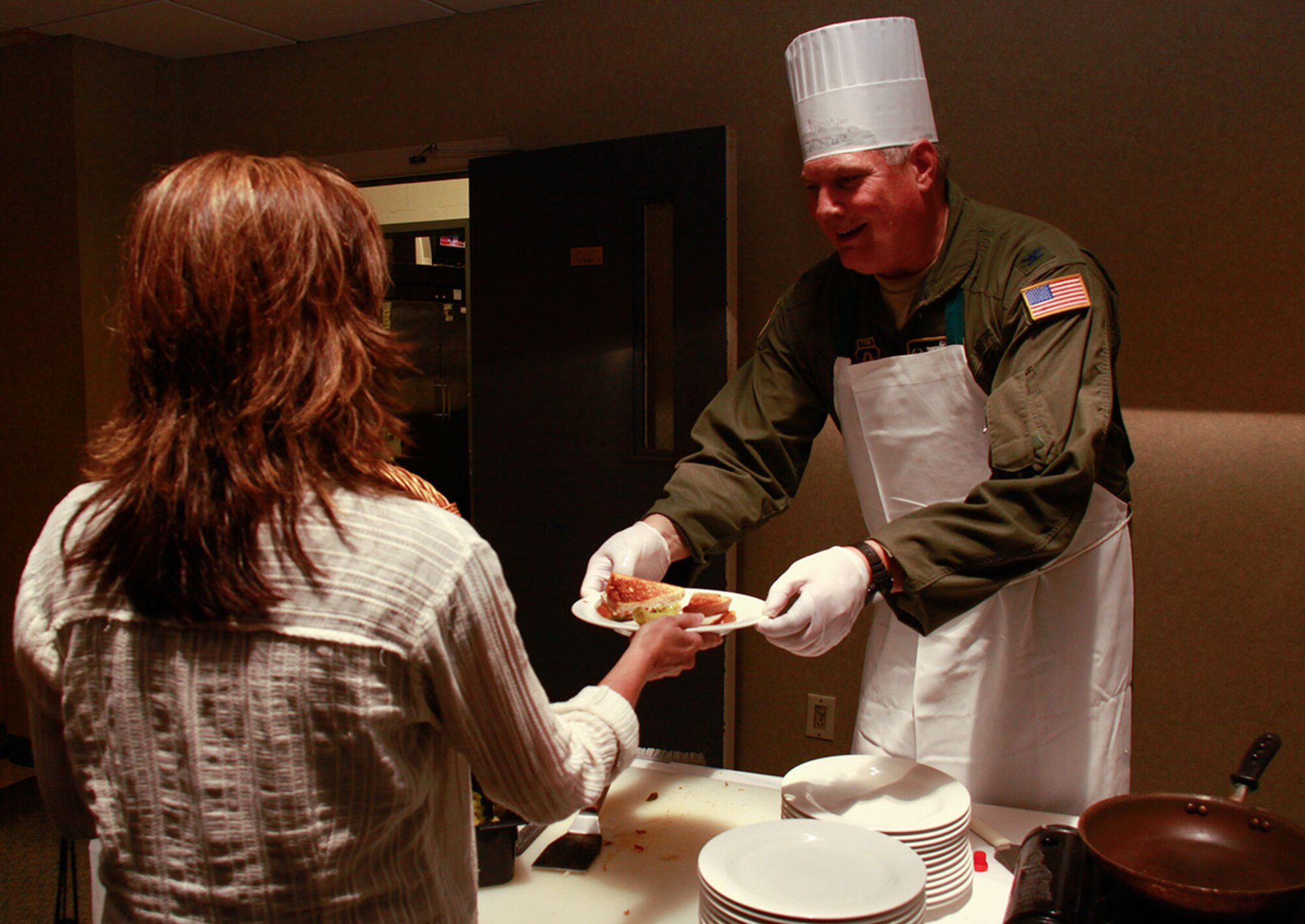 PITTSBURGH IAP ARS -- Col. Daryl J. Hartman, 911th Airlift Wing Operations Group commander, serves as “Dr. of Cheese” for Club Cargo Bay at the 911th AW, June 1, 2012. The Club invites multiple guest chefs, such as Col. Hartman, to serve fellow Airmen and civilian personnel during “Gourmet Grilled Cheese” luncheons. (U.S. Air Force photo by Airman 1st Class Justyne Obeldobel/Released)