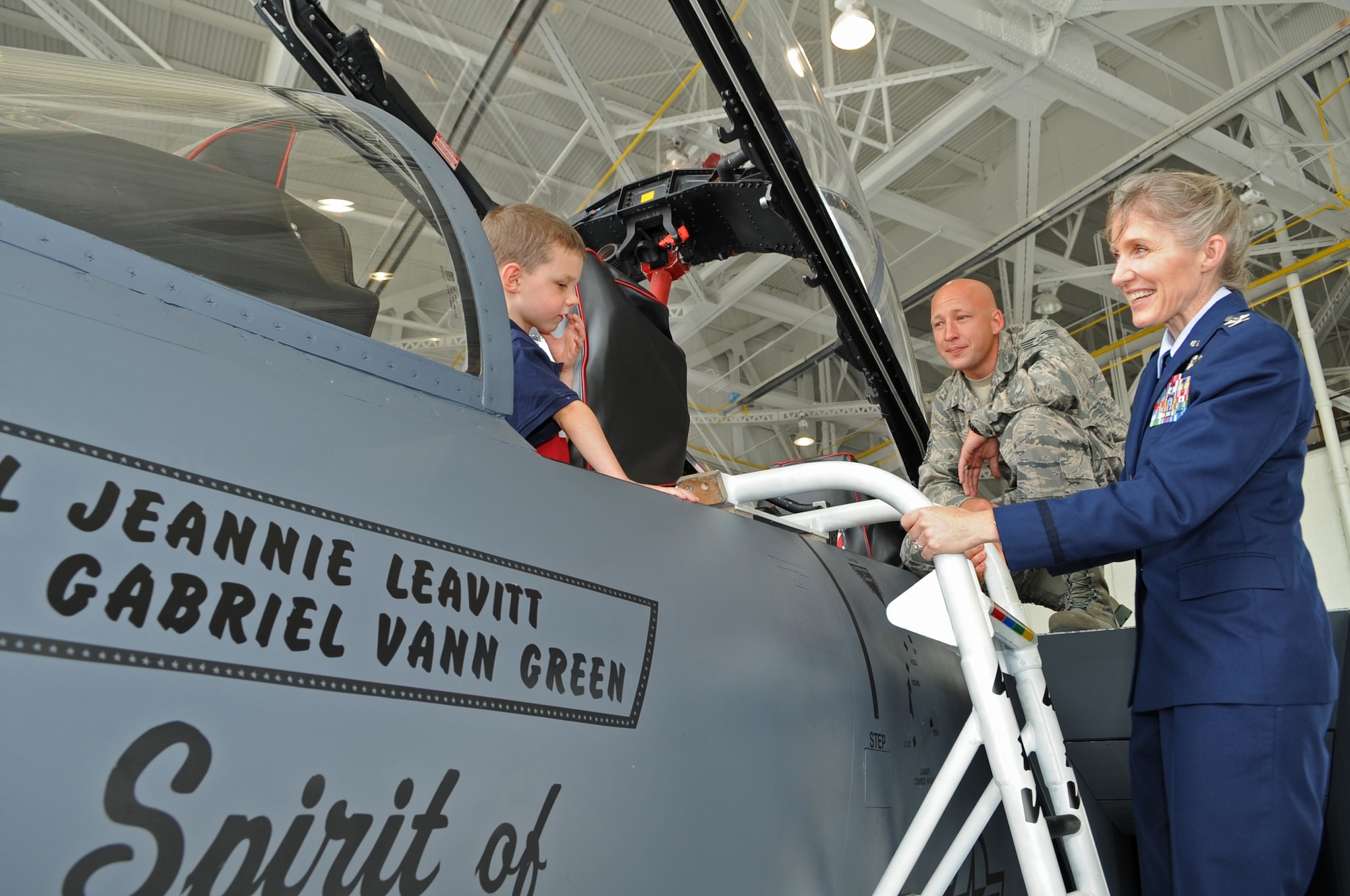 U.S. Air Force Col. Jeannie Leavitt smiles as her son Michael, 5, prepares to climb out of an F-15E Strike Eagle on Seymour Johnson Air Force Base, N.C., June 1, 2012. Leavitt, who assumed command of the 4th Fighter Wing during a ceremony earlier in the day, hails from St. Louis. (U.S. Air Force photo/Airman 1st Class Aubrey Robinson/Released)