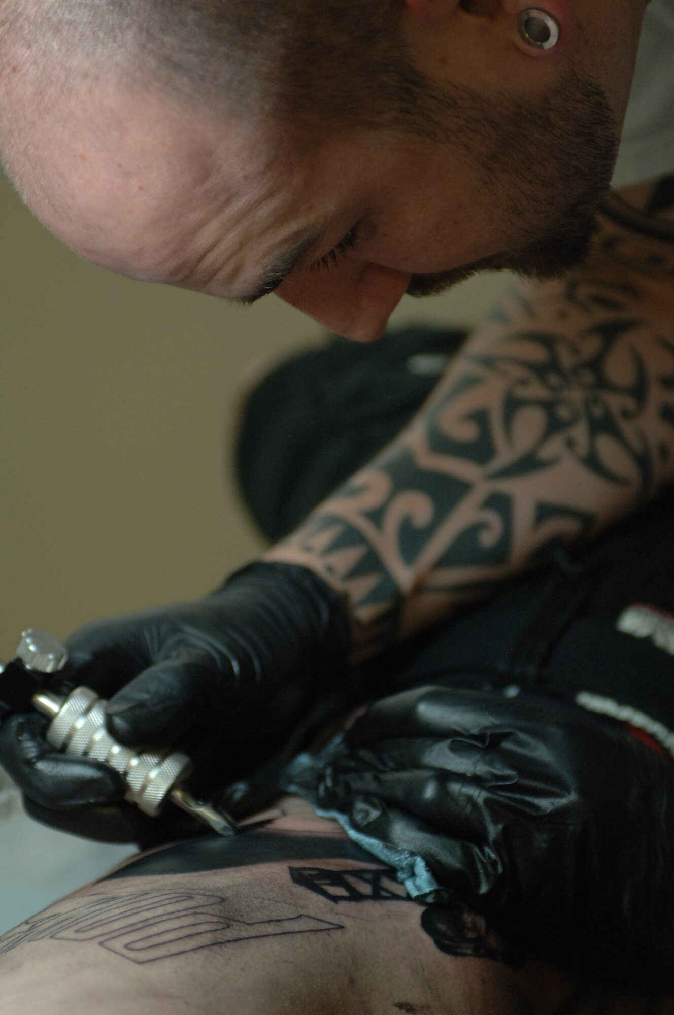 120530-F-DB561-0230
Former U.S. Air Force Staff Sgt. Matthew Pehrson, owner and operator of a local tattoo parlor, concentrates on a memorial tattoo, May 30, 2012, at Mountain Home, Idaho. Pehrson spends most of his time creating works of art for his most frequent customers – Airmen. (U.S. Air Force photo/Airman 1st Class Shane M. Phipps)
