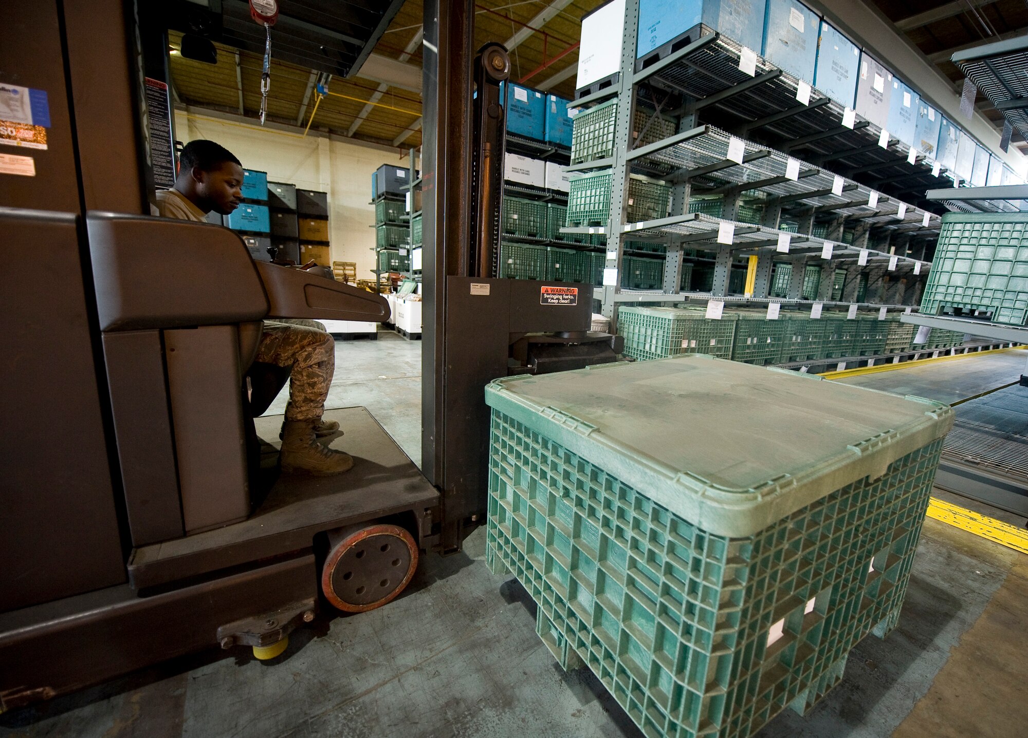 Senior Airman Marvin Miller, 2nd Logistics Readiness Squadron, lifts a crate with a forklift in the LRS warehouse on Barksdale Air Force Base, La., May 31. Airmen with the 2 LRS organize and keep accountability of aircraft parts, mobility equipment and weapons, and also distribute these items to the appropriate units as necessary. (U.S. Air Force photo/Staff Sgt. Chad Warren)(RELEASED)