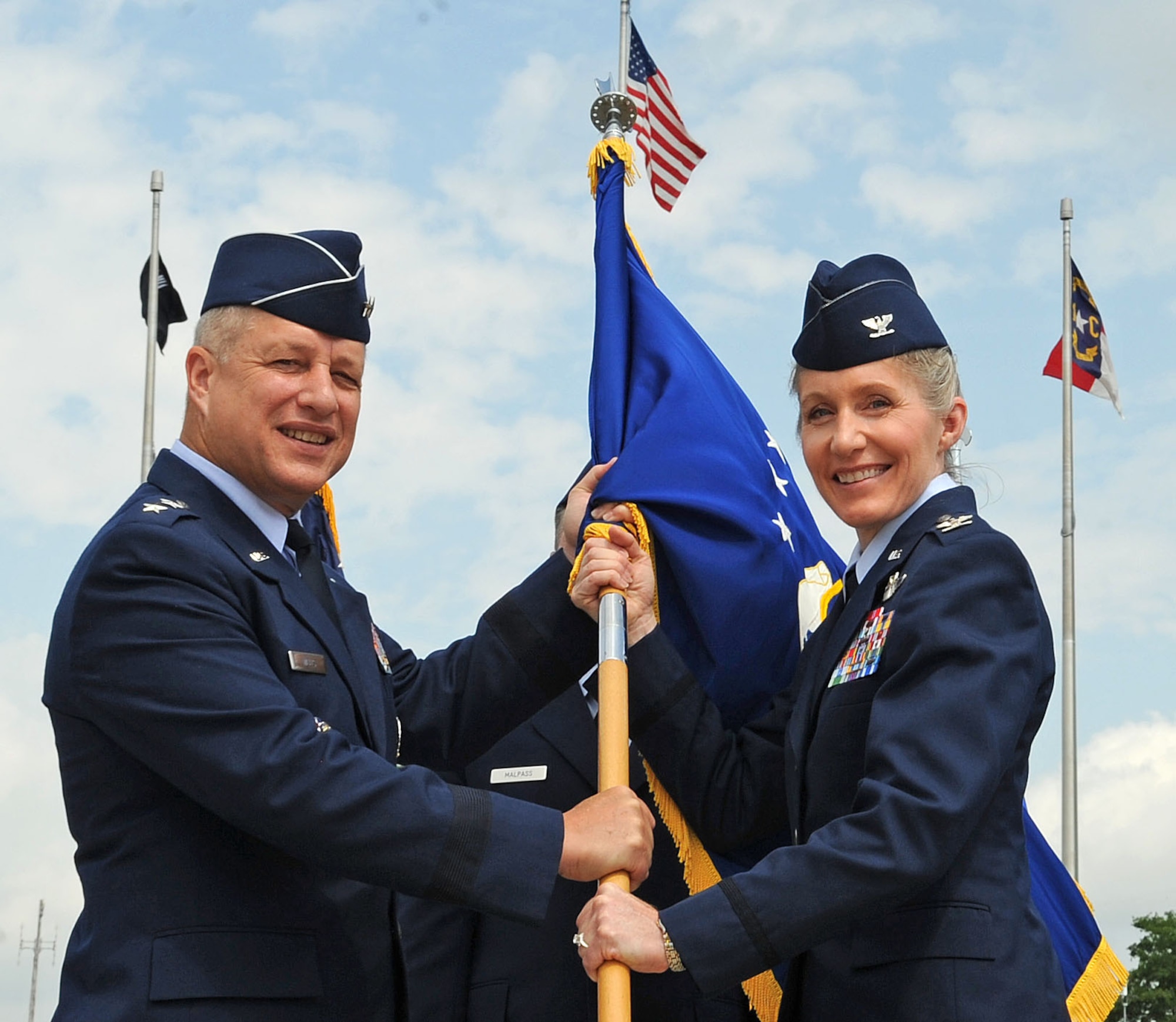 U.S. Air Force Maj. Gen. Lawrence Wells passes the guidon to Col. Jeannie Leavitt during the 4th Fighter Wing change of command ceremony on Seymour Johnson Air Force Base, N.C., June 1, 2012. Leavitt was the first woman to enter combat training as a fighter pilot and the first female fighter pilot to graduate weapons school. Wells is the 9th Air Force commander. (U.S. Air Force photo/Airman 1st Class Aubrey Robinson/Released)