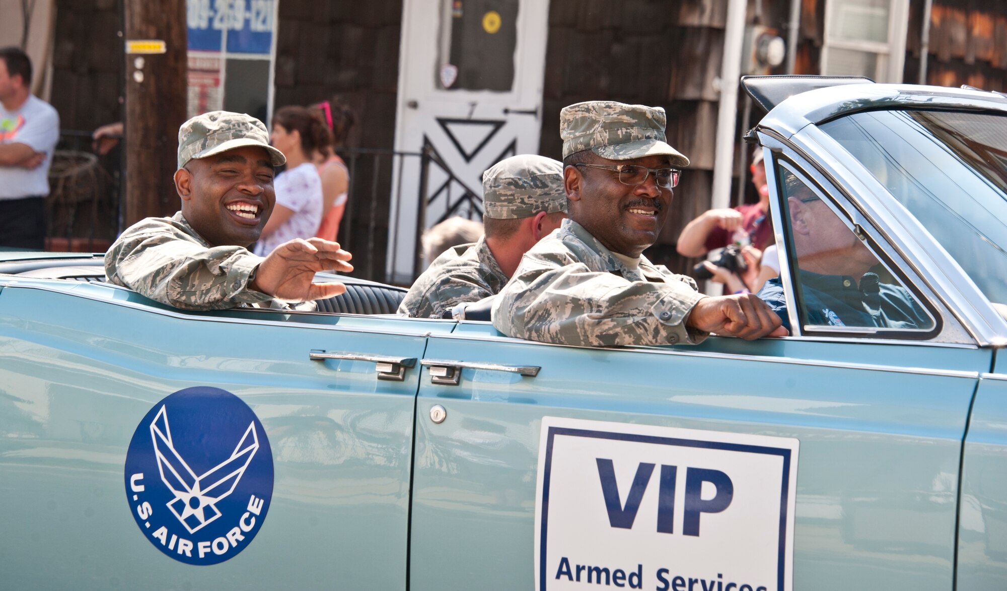 Tech. Sgt. Jamero Clark and Master Sgt. Stephan Clanton wave at the crowd during the Allentown Memorial Day Parade May 28. Thirteen Airmen from Joint Base McGuire-Dix-Lakehurst rode in various classic cars during this year’s Allentown Memorial Day parade. (U.S. Air Force photo by Staff Sgt. David Carbajal/Released)