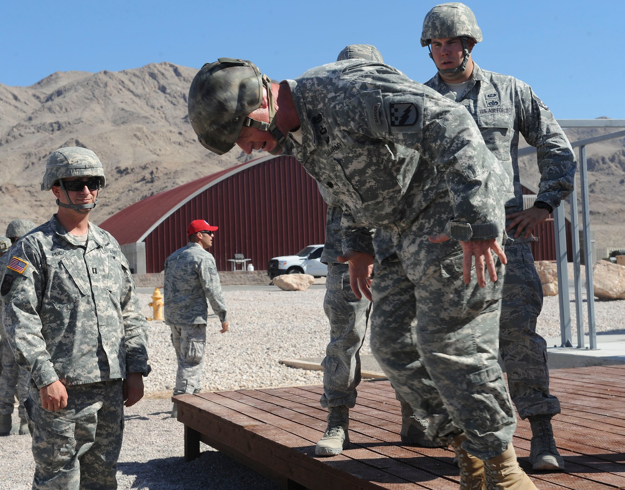 U.S. Army Lt. Col. Eric Crider, the 1-38th Cavalry Squadron commander, demonstrates the incorrect way to exit an aircraft during Mobility Forces Exercise 12A at Nellis Air Force Base, Nev., May 22, 2012. Airmen from the 820th RED HORSE Squadron and Soldiers from Ft. Bragg, N.C., jumped from C-130 Hercules aircraft at the Nevada Test and Training Range in Tonopah, Nev., to simulate setting up a bare base. (U.S. Air Force photo/Staff Sgt. Ciara Wymbs)