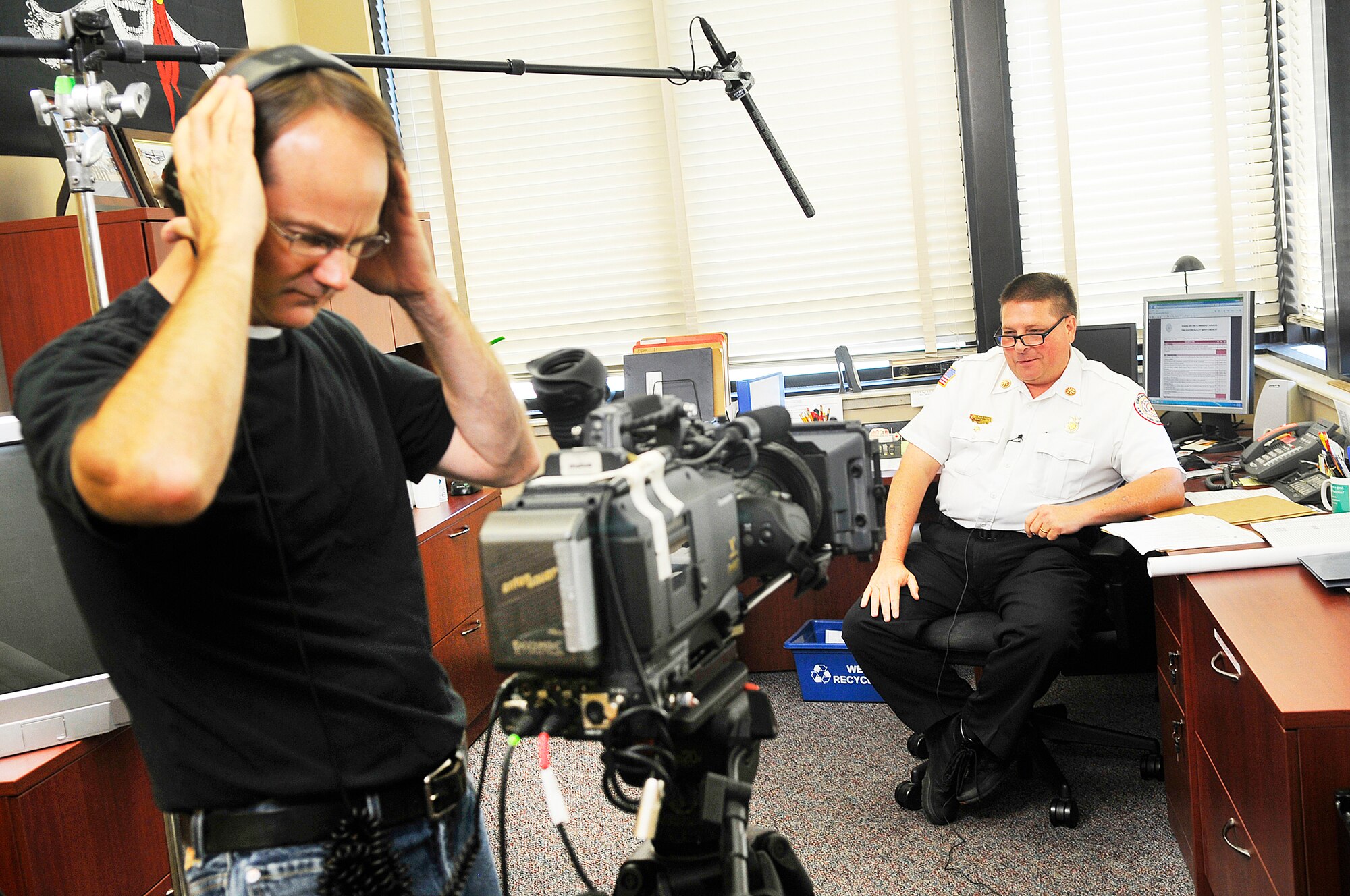 Tim Phillips, director/camera operator, gets prepared to interview Kevin Bartoe. A crew was at Robins May 21-23 to shoot photos and film segments for an Air Force Health and Safety Officer training course.  (U. S. Air Force photo by Sue Sapp)
