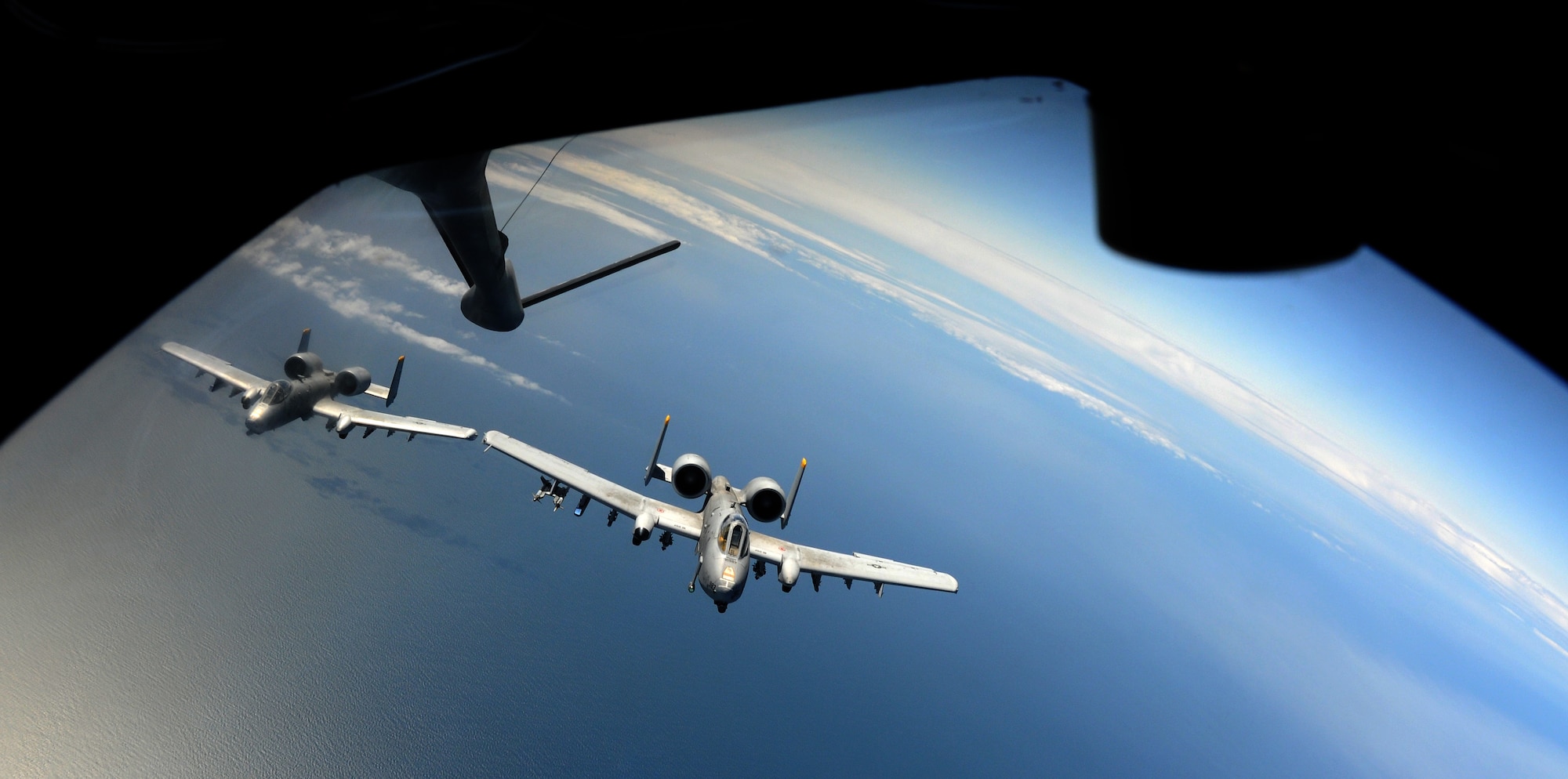 SWEDISH AIR SPACE -- Two A-10 Thunderbolt II aircraft, call signs Growler 11 and 12 from Spangdahlem Air Base, Germany, fly in formation in Swedish air space behind a 100th Air Refueling Wing KC-135 Stratotanker after receiving fuel during the Baltic Region Training Event XII May 30, 2012. BRTE XII was a NATO exercise that included support from several countries including the United States, France, Estonia and Latvia. (U.S. Air Force photo/Staff Sgt. Thomas Trower)