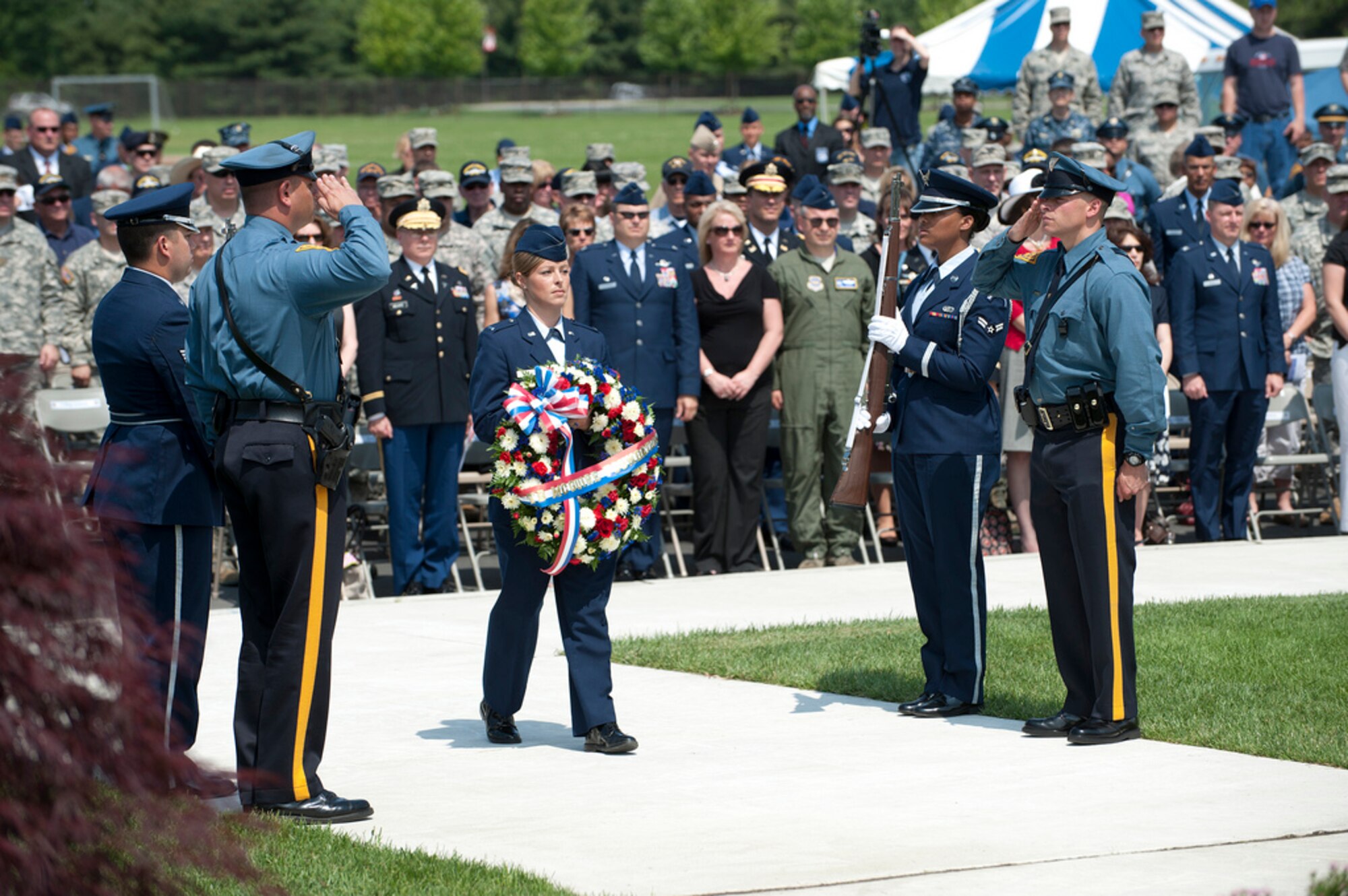 First Lt. Dempsey Bird, 87th Communications Squadron operations flight commander, walks to lay the first wreath for the Tommy B. McGuire Foundation under the P-38 Lightning in Pudgy’s Circle for the Parade of Wreaths Ceremony May 24 here. Bird hails from Elverson, Pa. The wreath laying is a tribute to those who gave their lives in service to our country. Guest speakers were Brig. Gen. Scott P. Goodwin, U.S. Air Force Expeditionary Center commandant, and Lt. Col. Matthew M. Wilson, N.J. State Police deputy superintendent of investigations. The ceremony also featured a U.S. Marine Corps helicopter flyover, the N.J. State Police Pipes and Drums of the Blue and Gold, and the North Hanover Township School District children’s choir. (U.S. Air Force photo by Russ Meseroll/Released)