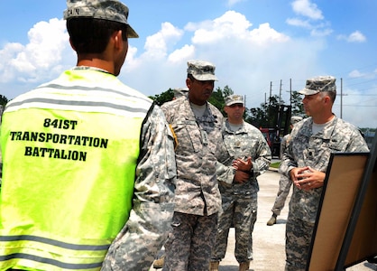 Army Lt. Gen. Vincent Brooks, Third Army commanding general, is briefed by Lt. Col. Andy Dawson, 841st Transportation Battalion Operations commander, at the Transportation Command Dock May 23, 2012 at Joint Base Charleston – Weapons Station. Brooks visited JB Charleston to get a first-hand look at the military functions that are unique to this base. (U.S. Air Force photo/Airman 1st Class Ashlee Galloway)