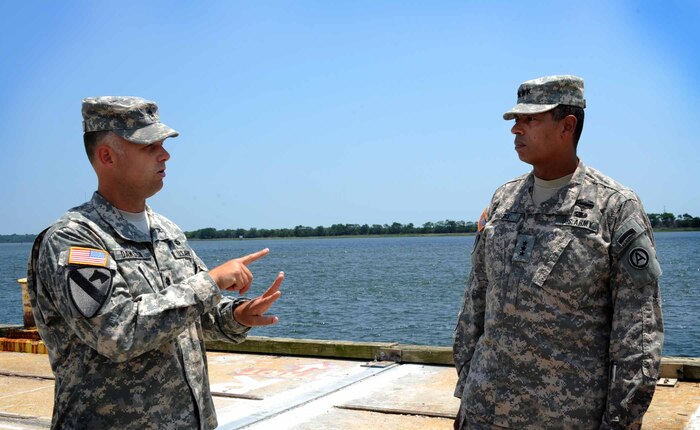 Army Lt. Gen. Vincent Brooks, Third Army commanding general, is briefed by Lt. Col. Andy Dawson, 841st Transportation Battalion Operations commander, at the Transportation Command Dock May 23, 2012 at Joint Base Charleston – Weapons Station. Brooks visited JB Charleston to get a first-hand look at the military functions that are unique to this base. (U.S. Air Force photo/Airman 1st Class Ashlee Galloway)