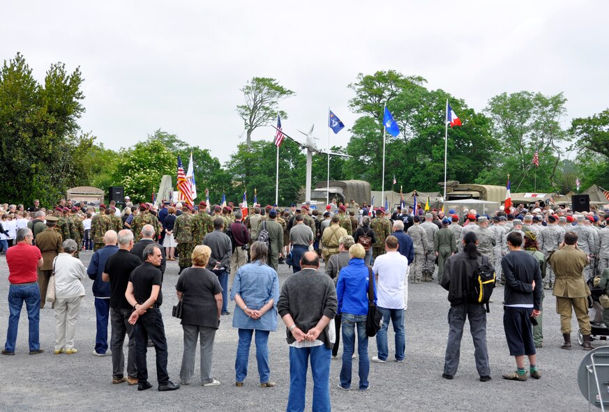 A crowd hears June 1, 2012, the names of Airmen killed during the initial D-Day invasion of Normandy in the town square of Picauville, France. U.S. and allied forces attended a commerative ceremony honoring the Airmen and soldiers who lost their lives during the famous Normandy D-Day invasion. A memorial erected within Picauville pays tribute to Airmen of the 9th Air Force as well as 82nd and 101st Airborne paratroopers who lost their lives when their C-47 Skytrain aircraft were brought down by German anti-aircraft artillery in the early morning hours of June 6, 1944. The aircrews and paratroopers paid the ultimate sacrifice supporting the invasion. Members of the Air Force Reserve Command's 302nd, 910th and 440th Airlift Wings took part in this year's 68th Anniversary commemoration of the historic invasion. (U.S. Air Force photo/Staff Sgt. Stephen J. Collier)