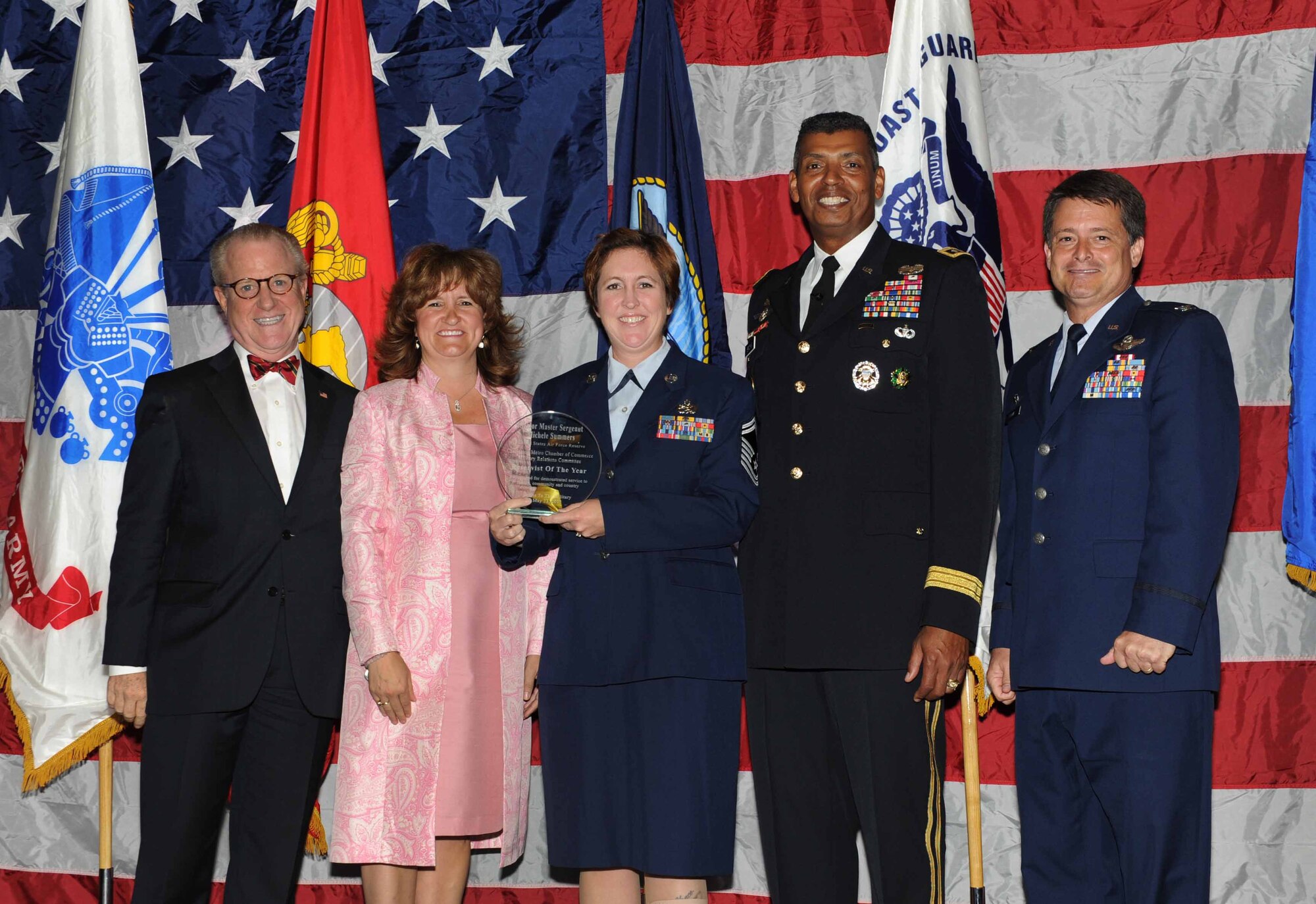 Peter Wertimer, Charleston Chamber of Military Policy council chairman, Julie Gerthoffer, Charleston Chamber of Military Relations Committee and U.S. Army Lt. Gen. Vincent Brooks, Third Army commanding general, present Senior Master Sgt. Michele Summers, 315th Airlift Wing, the 'Reservists of the Year' award, alongside her commanding officer, Col. Russell Finger, 315th Airlift Wing commander, during 'Salute to the Military' May 23, 2012 at the North Charleston Convention Center, S.C. This is the eighth year the Charleston Metro Chamber of Commerce recognized the local active-duty, reserve, and civilian personnel for their community service above and beyond their call of duty. (U.S. Air Force photo/Airman 1st Class Ashlee Galloway)