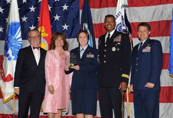 Peter Wertimer, Charleston Chamber of Military Policy council chairman, Julie Gerthoffer, Charleston Chamber of Military Relations Committee and U.S. Army Lt. Gen. Vincent Brooks, Third Army commanding general, present Senior Master Sgt. Michele Summers, 315th Airlift Wing, the 'Reservists of the Year' award, alongside her commanding officer, Col. Russell Finger, 315th Airlift Wing commander, during 'Salute to the Military' May 23, 2012 at the North Charleston Convention Center, S.C. This is the eighth year the Charleston Metro Chamber of Commerce recognized the local active-duty, reserve, and civilian personnel for their community service above and beyond their call of duty. (U.S. Air Force photo/Airman 1st Class Ashlee Galloway)